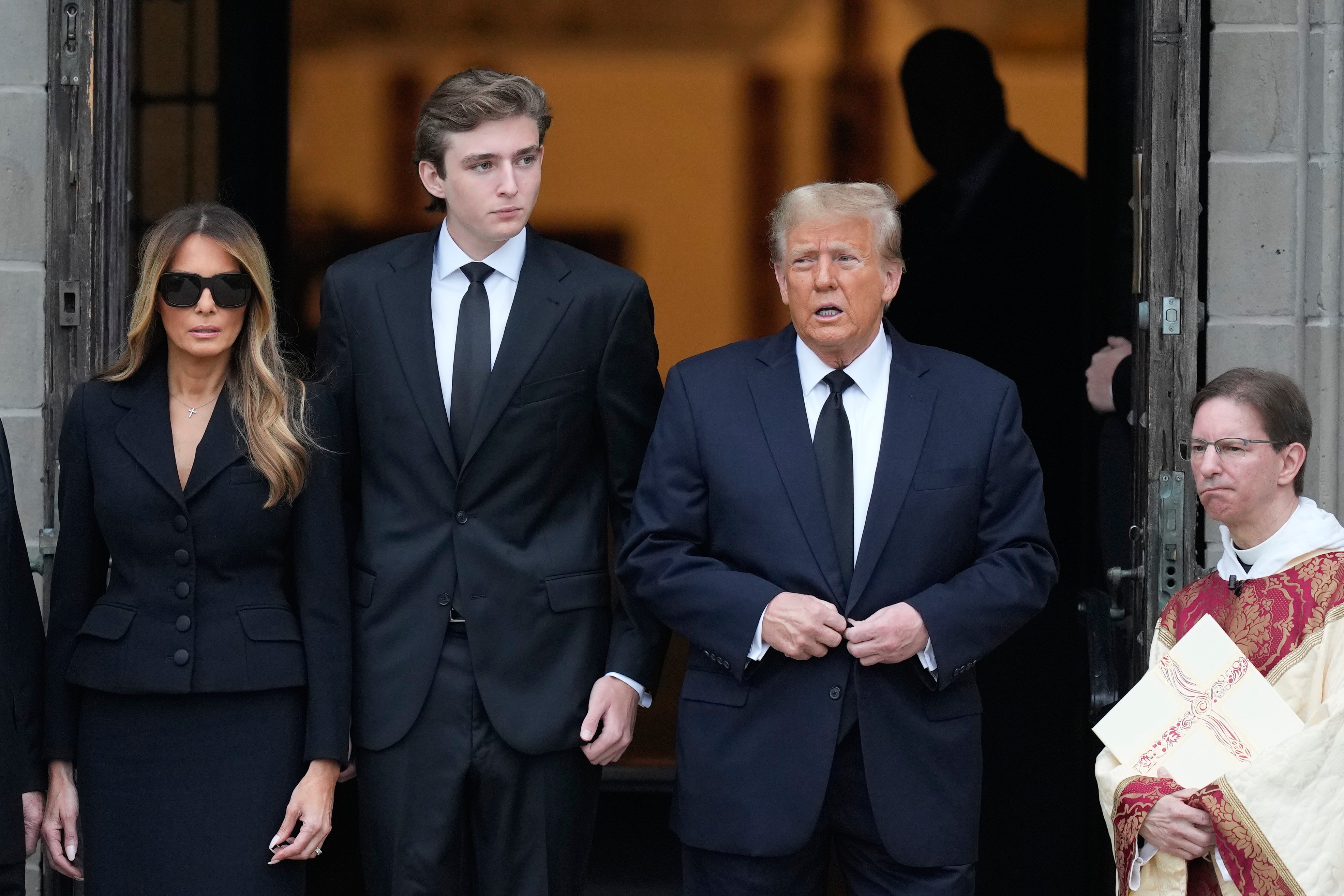 Barron Trump (center) towers over 6ft 3in dad Donald and mom Melania in July