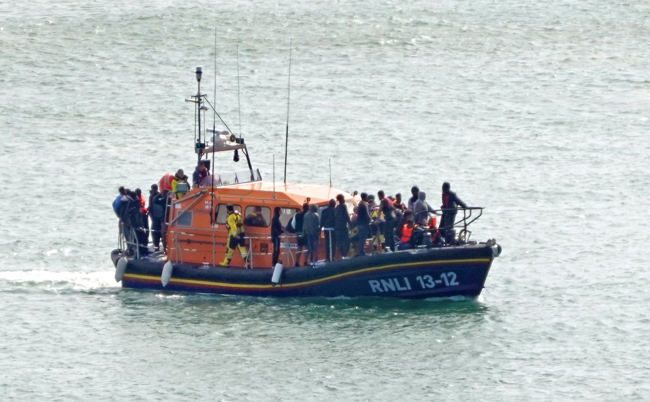 A group of people thought to be migrants are brought in to Dover onboard an RNLI lifeboat following a small boat incident in the English Channel (Gareth Fuller/PA)