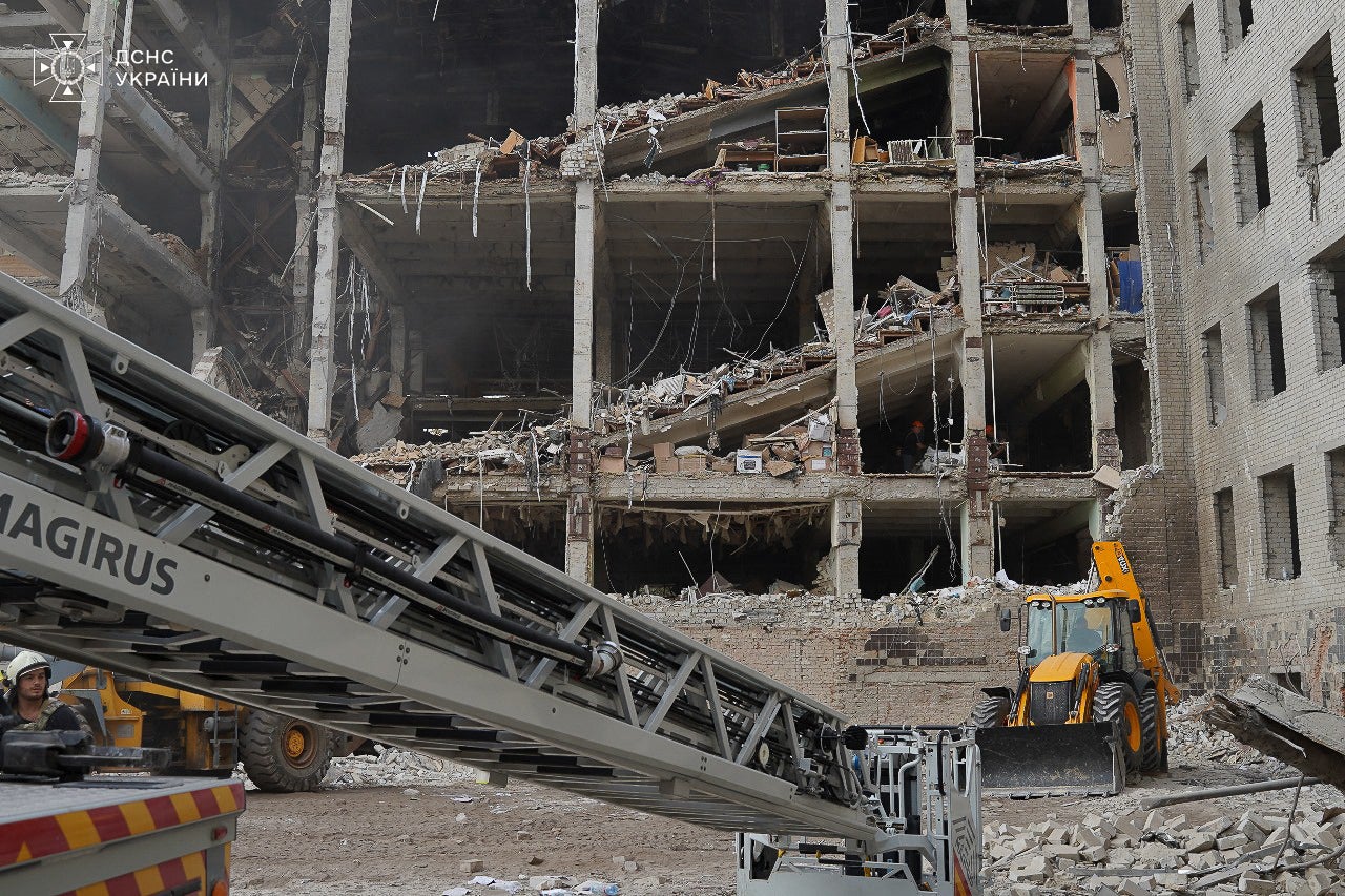 Ukrainian rescuers work in the military communications institute in Poltava, eastern Ukraine, two days after it was hit by Russian missiles