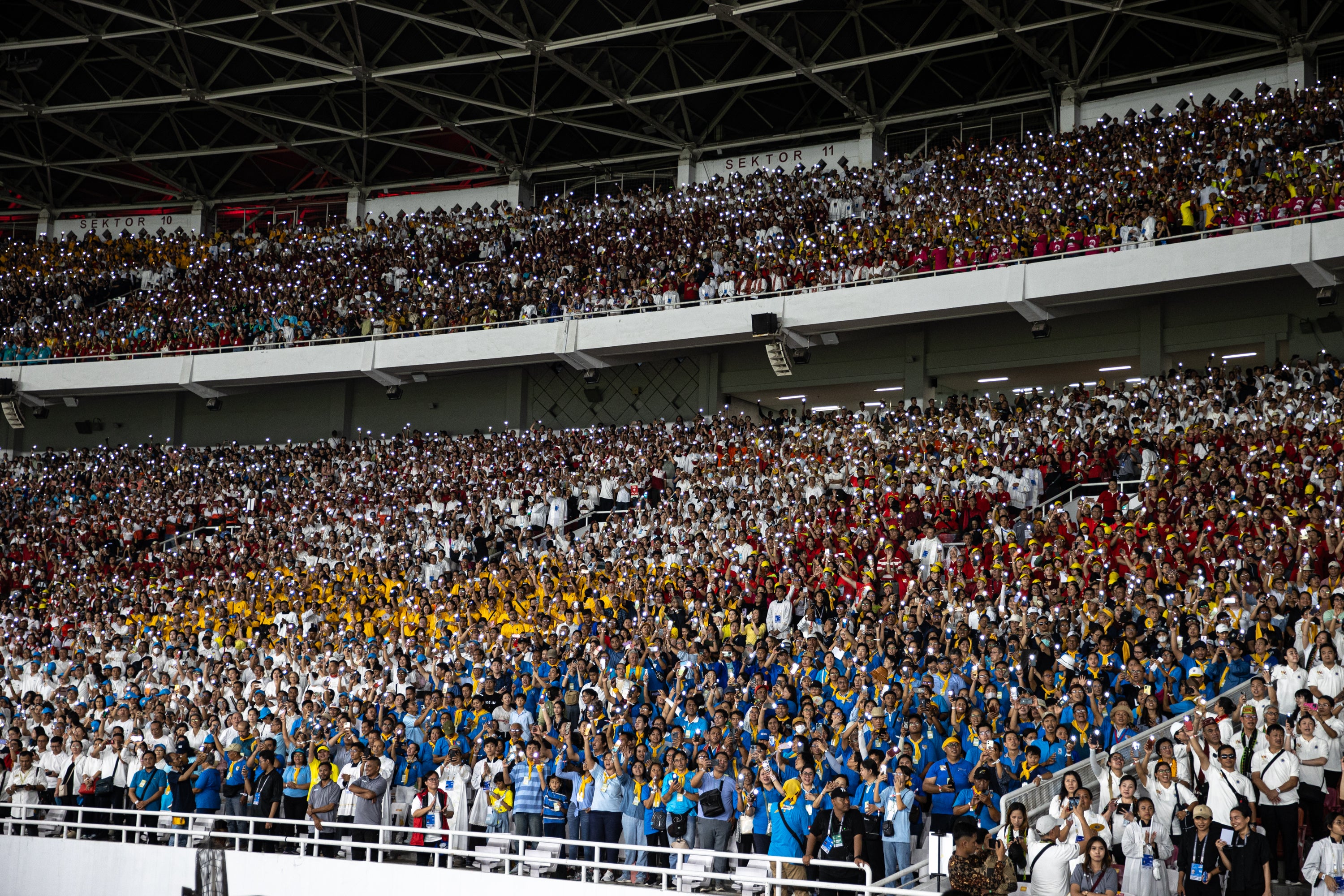 Indonesian Catholics attend the Holy mass lead by Pope Francis at Gelora Bung Karno Stadium