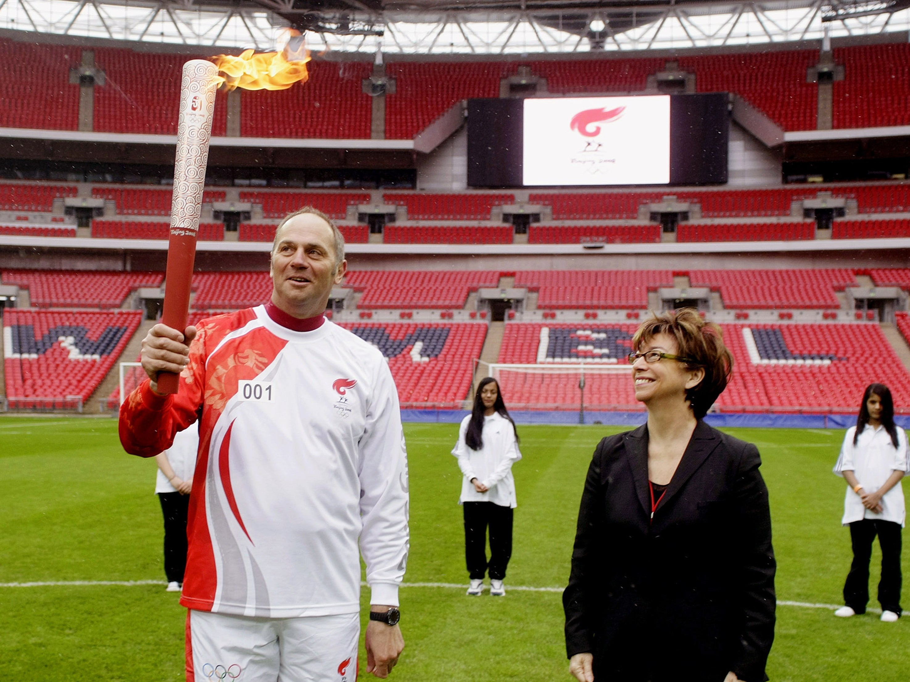 Alongside athlete Steve Redgrave with the Olympic torch at Wembley Stadium in 2008