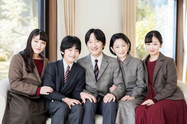 <p>In this photo provided by Japan's Imperial Household Agency of Japan, Crown Prince Akishino, centre, poses for a photograph with his wife Crown Princess Kiko, second right, and their children, Princess Mako, left, Princess Kako, right, and Prince Hisahito, second left, at their residence in Tokyo on 14 November 2020</p>