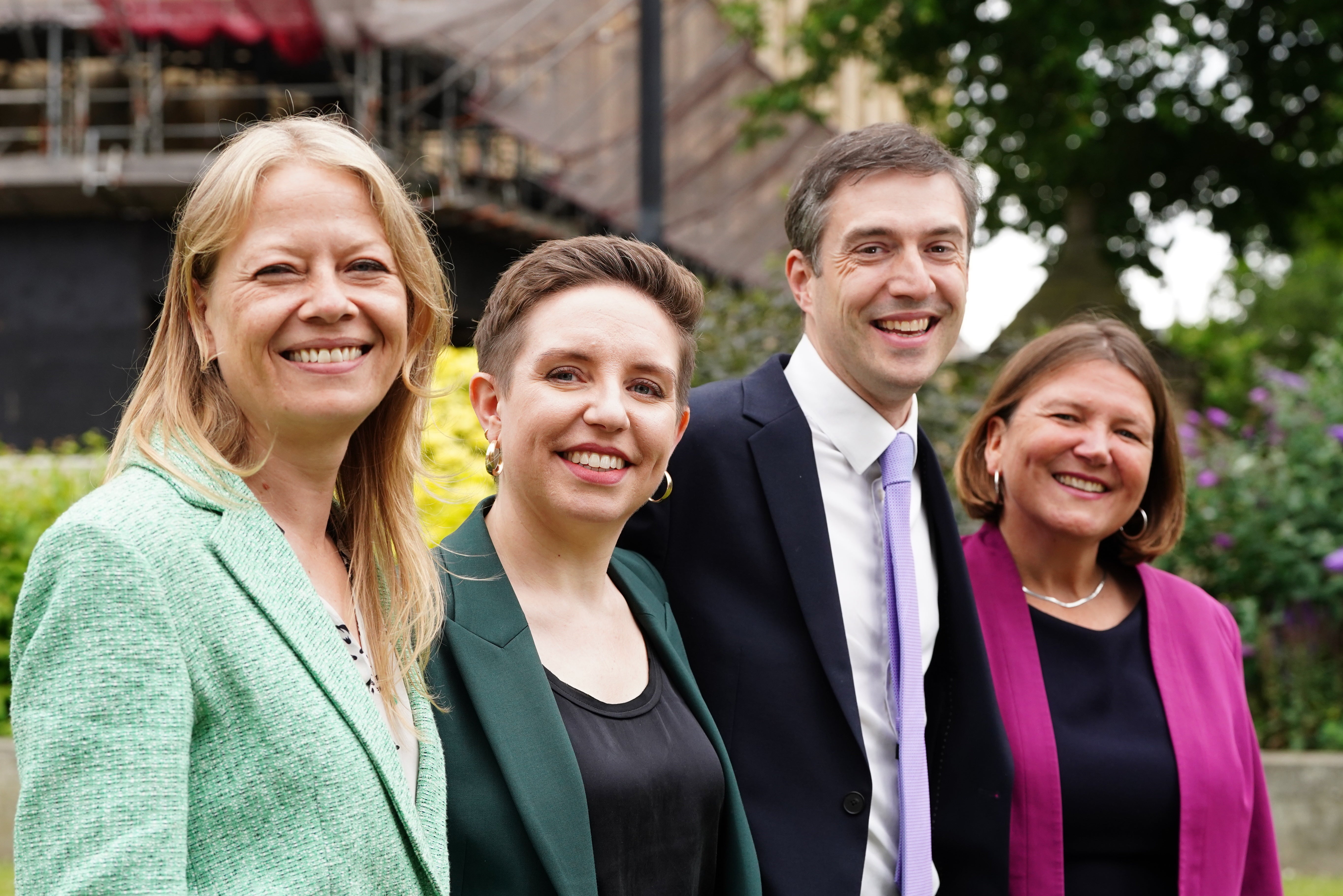 The four new Green MPs who won seats in the 2024 general election (l to r) Sian Berry (MP for Brighton Pavilion), party co-leader Carla Denyer (MP for Bristol Central), party co-leader Adrian Ramsay (MP for Waveney Valley) and Ellie Chowns (MP for North Herefordshire) pose for photos on College Green opposite the Palace of Westminster (Ian West/PA)