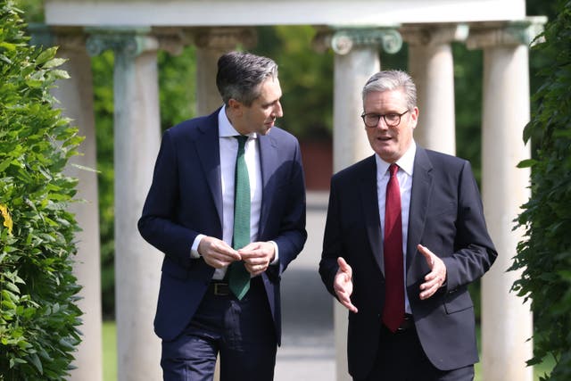 <p>Taoiseach Simon Harris walks with Prime Minister Sir Keir Starmer at Farmleigh House</p>