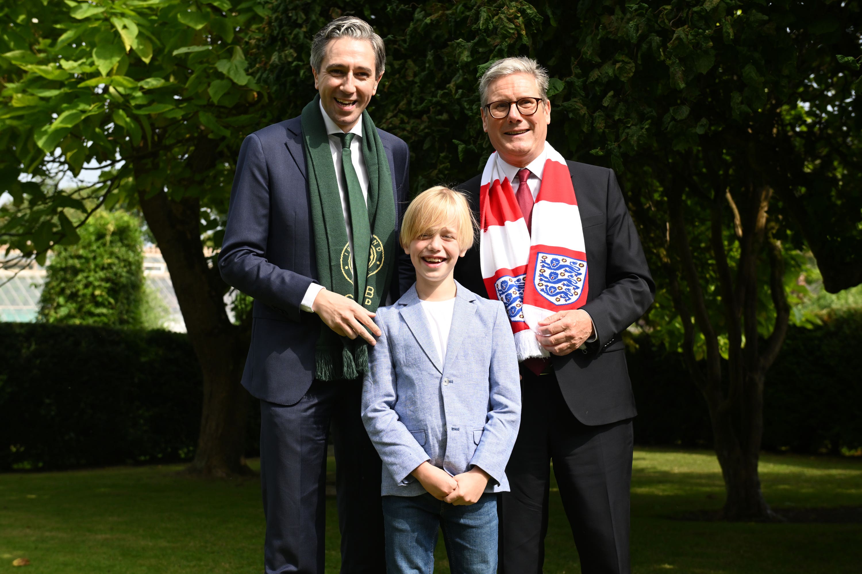 Simon Harris and Sir Keir Starmer, met nine-year-old Freddie Munnelly at Farmleigh House in Dublin (PA)