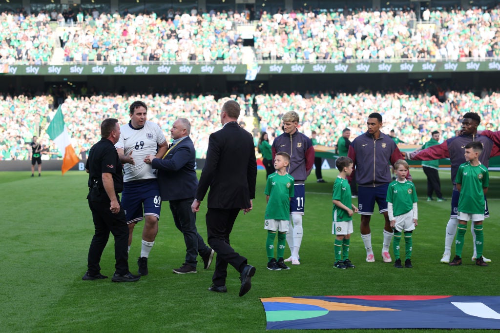 A pitch invader joins the England team line-up