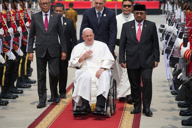 <p>File: Pope Francis is assisted past a guard of honour ahead of his departure from Jakarta’s Soekarno-Hatta International Airport to Papua New Guinea’s capital Port Moresby</p>