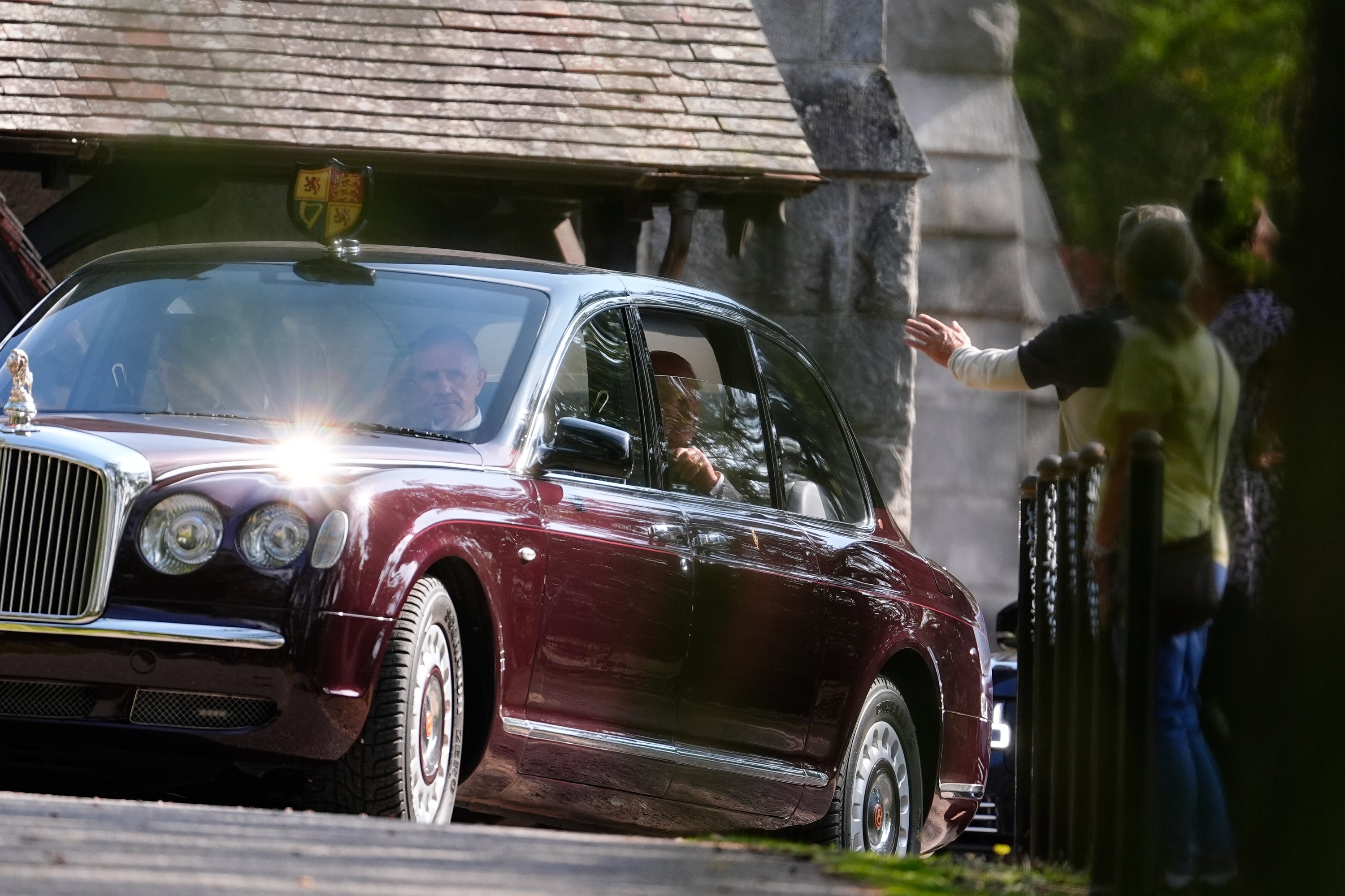 A small crowd gathered to see the King arrive at the church, as he sat in the back seat of the maroon state Bentley with Camilla at his side as they arrived at the church at 11.25am