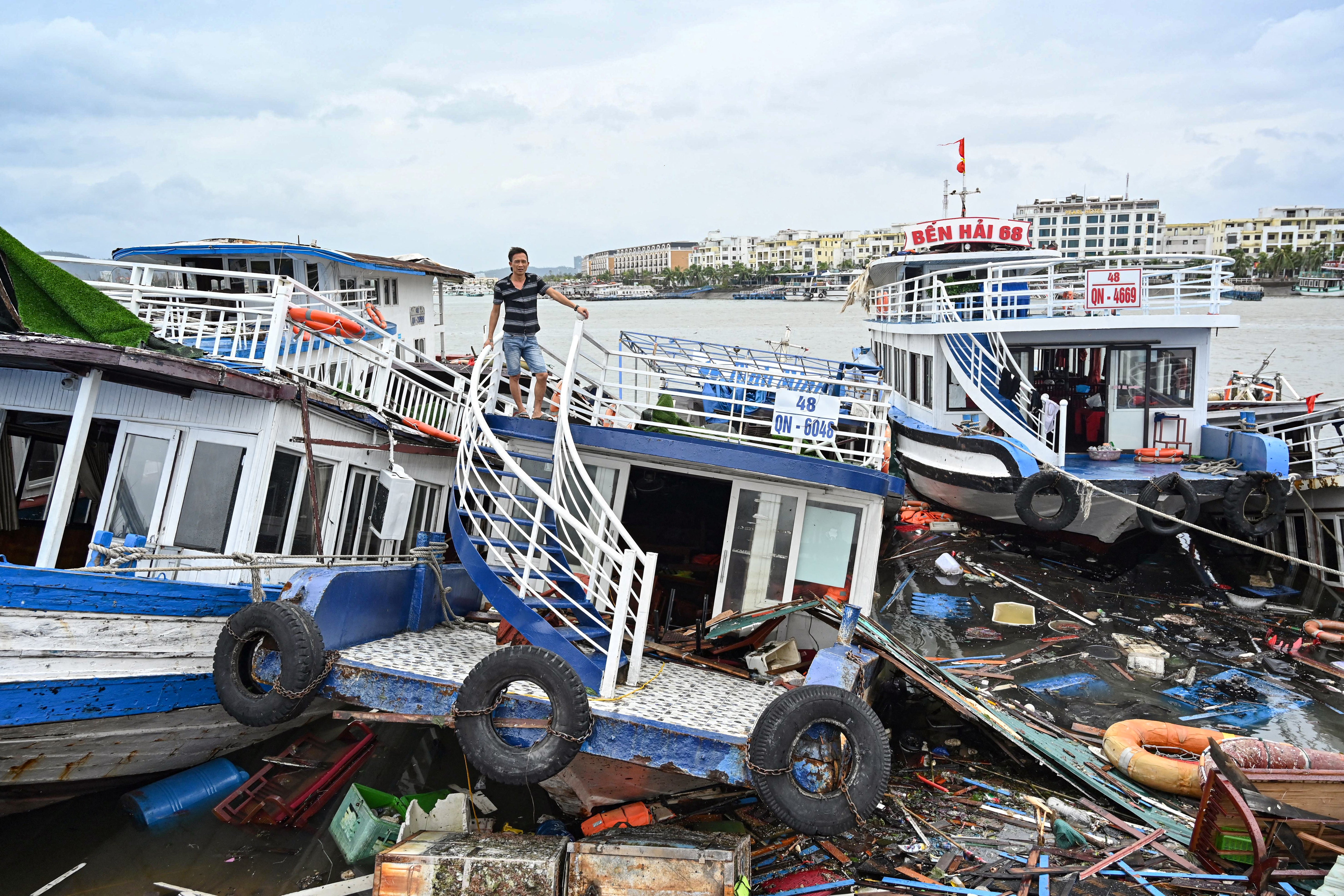 A man checks his damaged boat after Super Typhoon Yagi hit Ha Long bay, in Quang Ninh province, on 8 September 2024