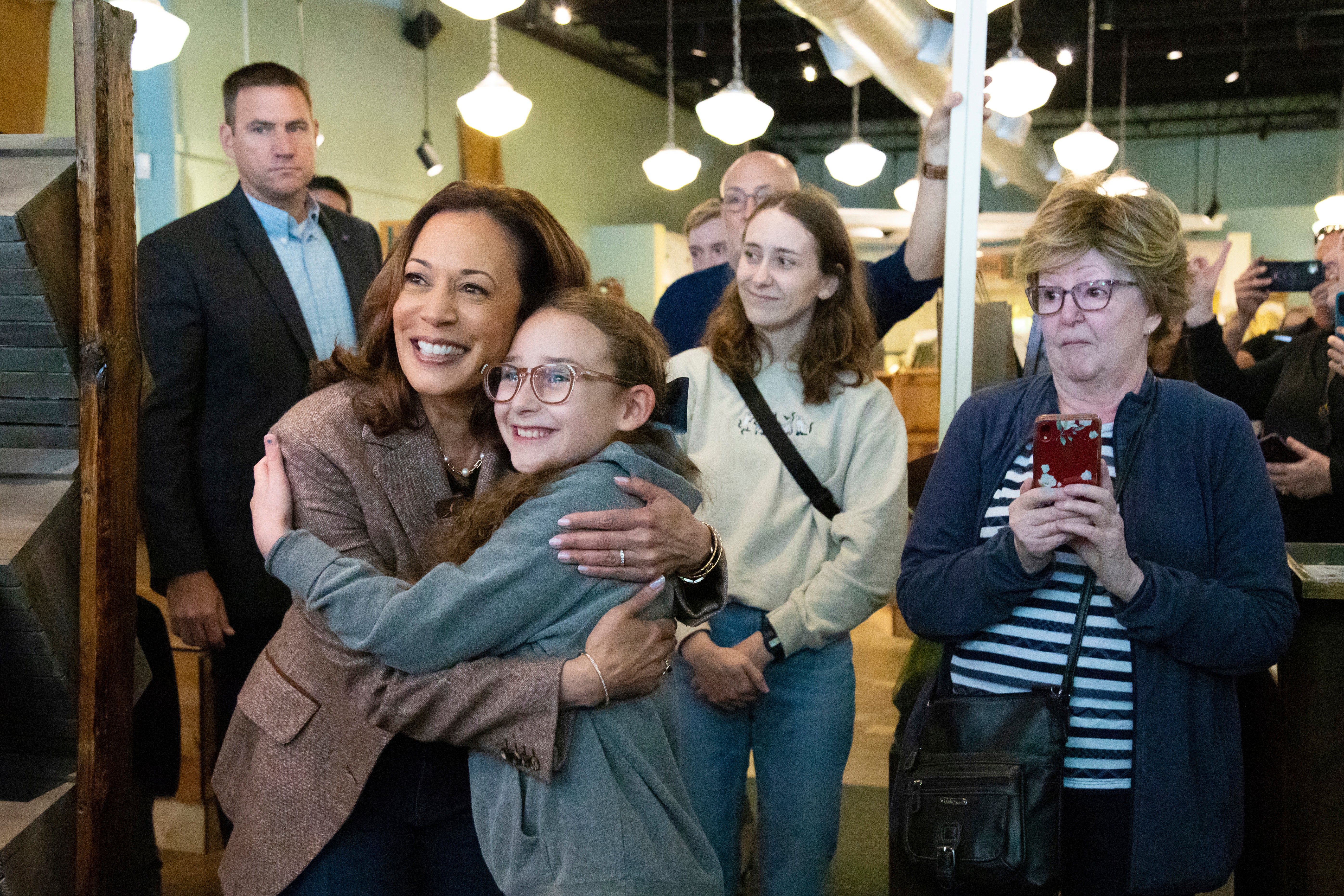 Kamala Harris takes a photo as she visits Penzeys Spices on a campaign stop in Pittsburgh on Saturday