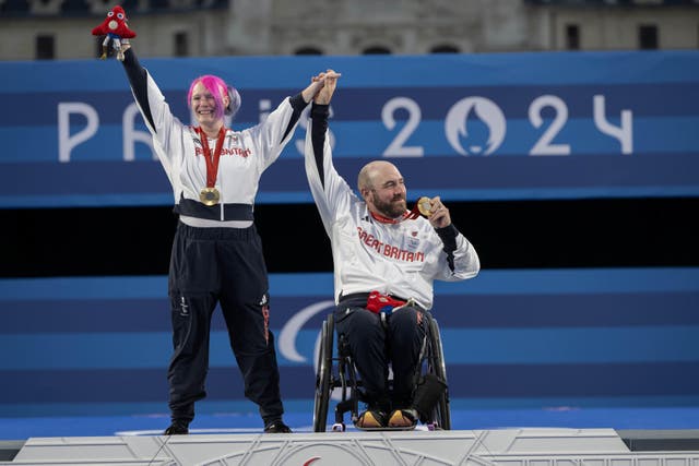 Great Britain’s Jodie Grinham and Nathan Macqueen celebrate winning gold in the mixed team compound (ParalympicsGB/PA)