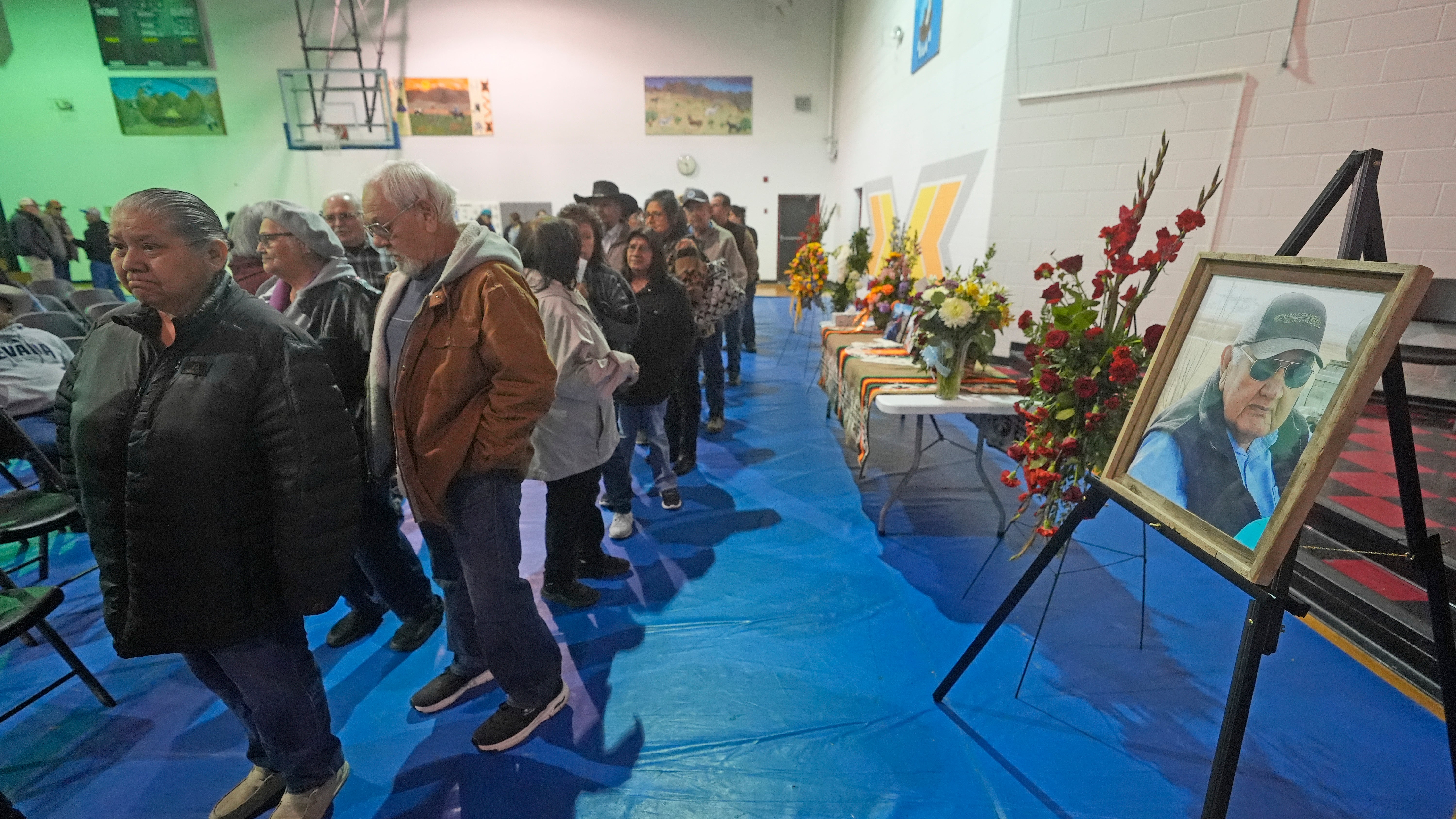 Tribal members gather in a gymnasium to pay their respects to Marvin Cota