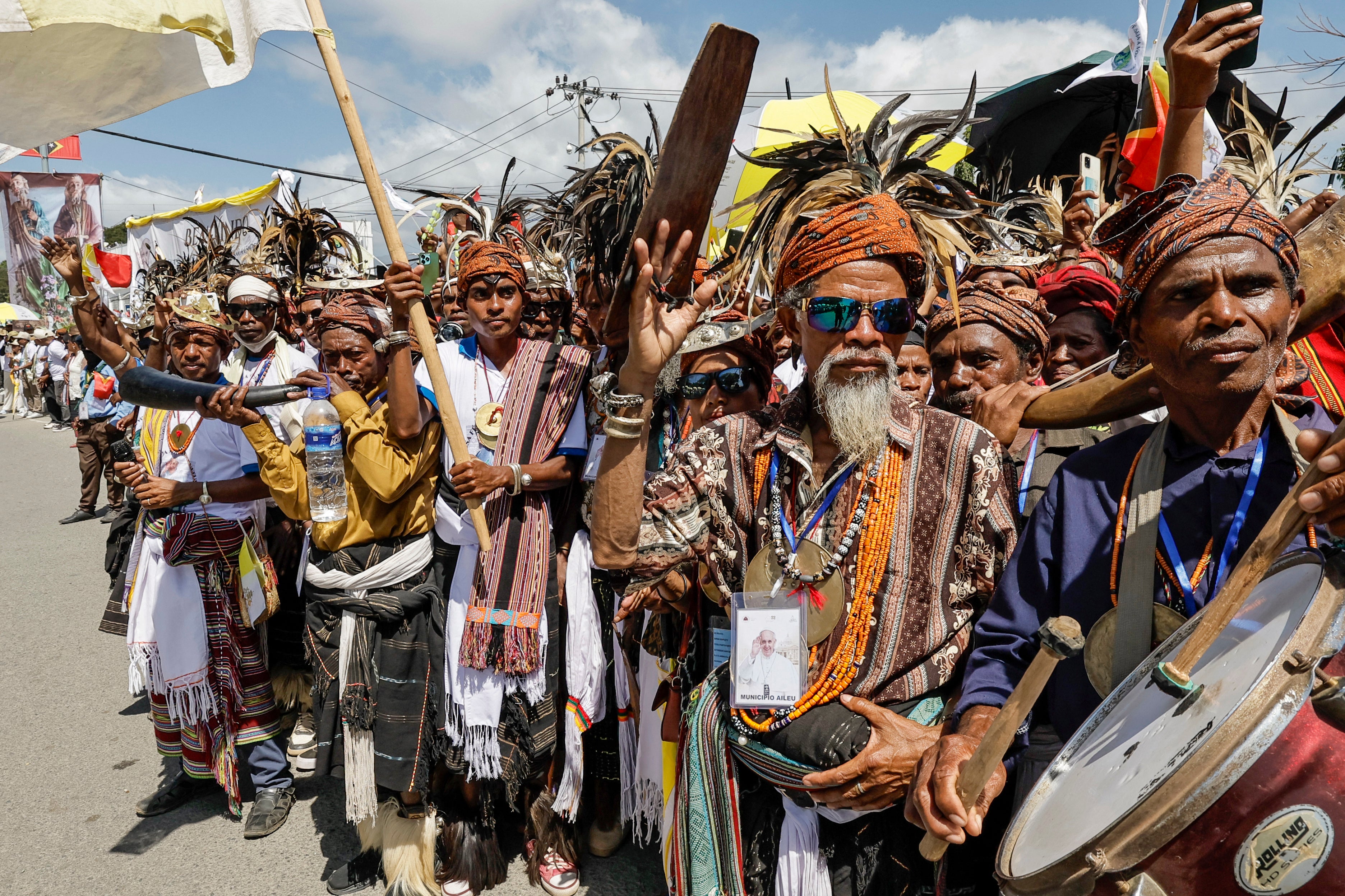 Catholic faithful wait to welcome Pope Francis