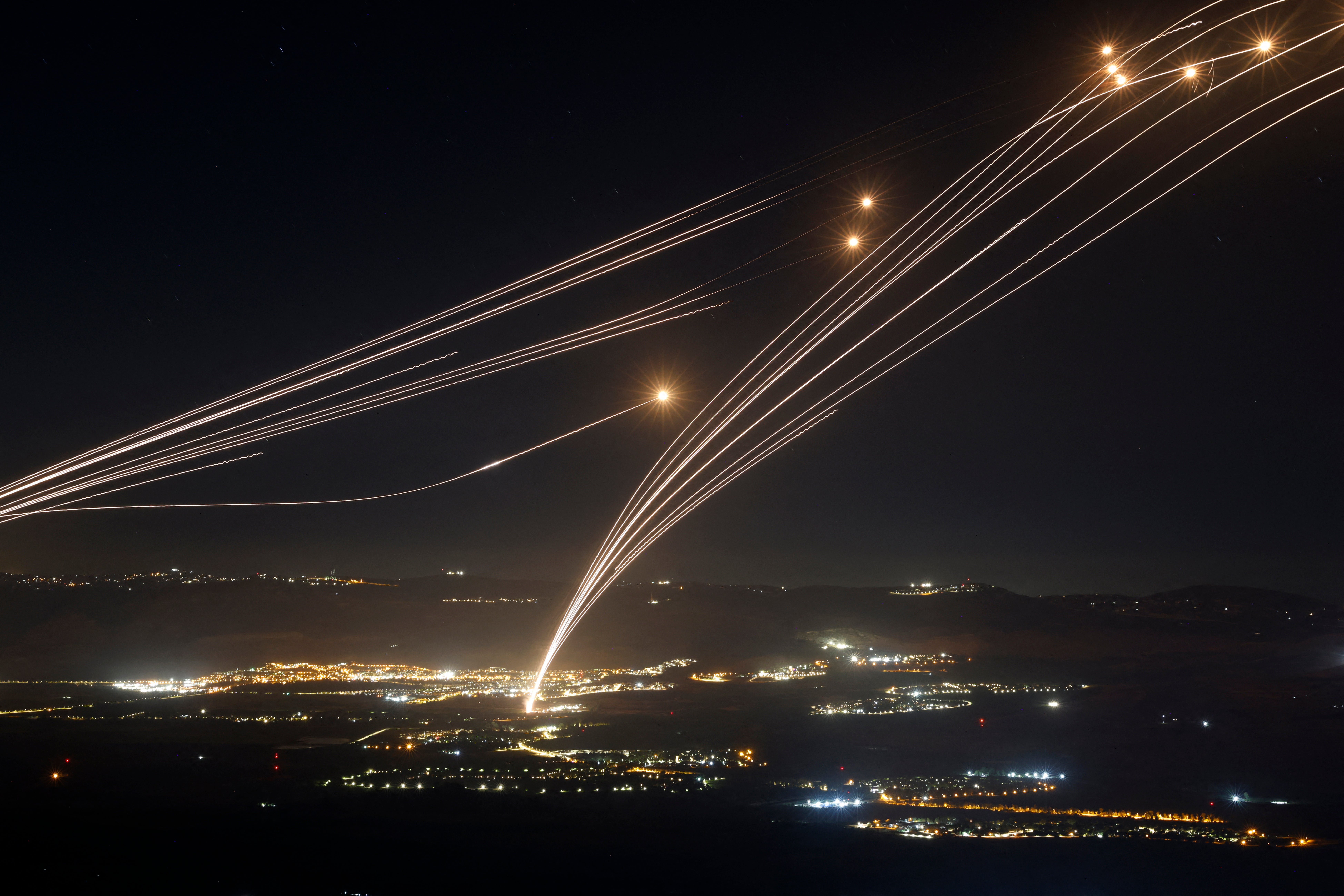 Rockets fired from southern Lebanon are intercepted by Israeli air defences over the Upper Galilee region in northern Israel