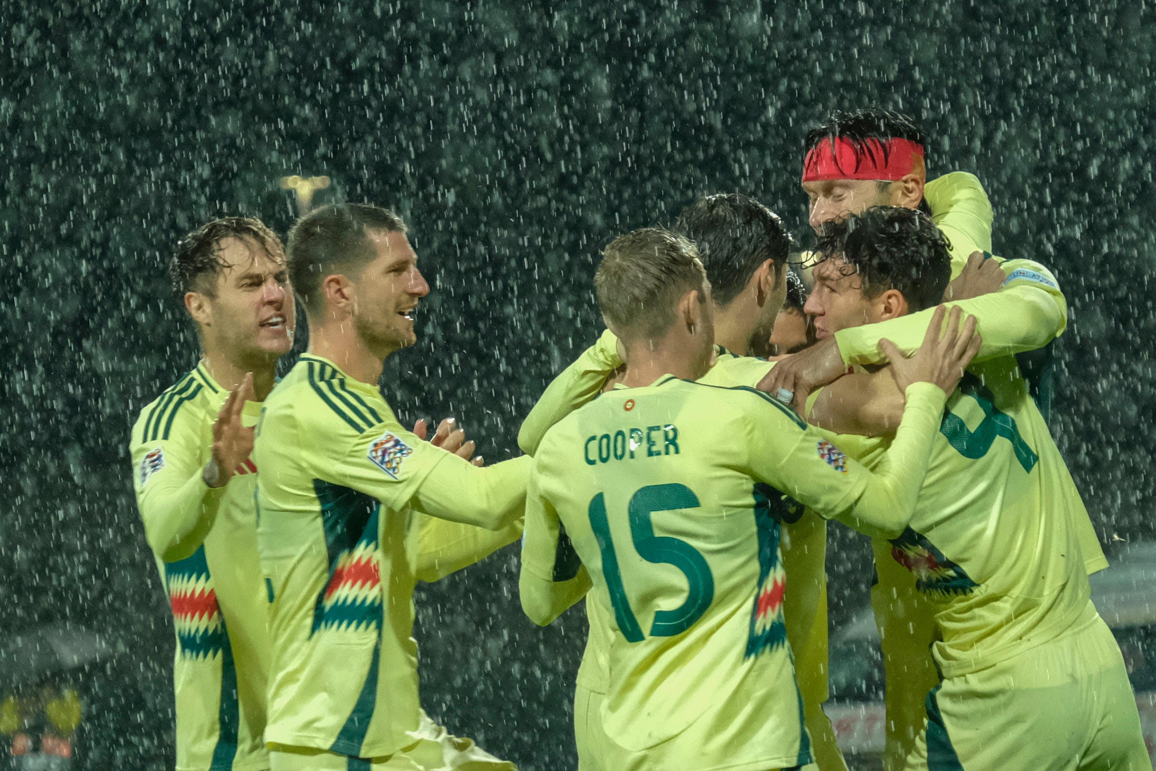 Kieffer Moore (headband) celebrates with his Wales teammates