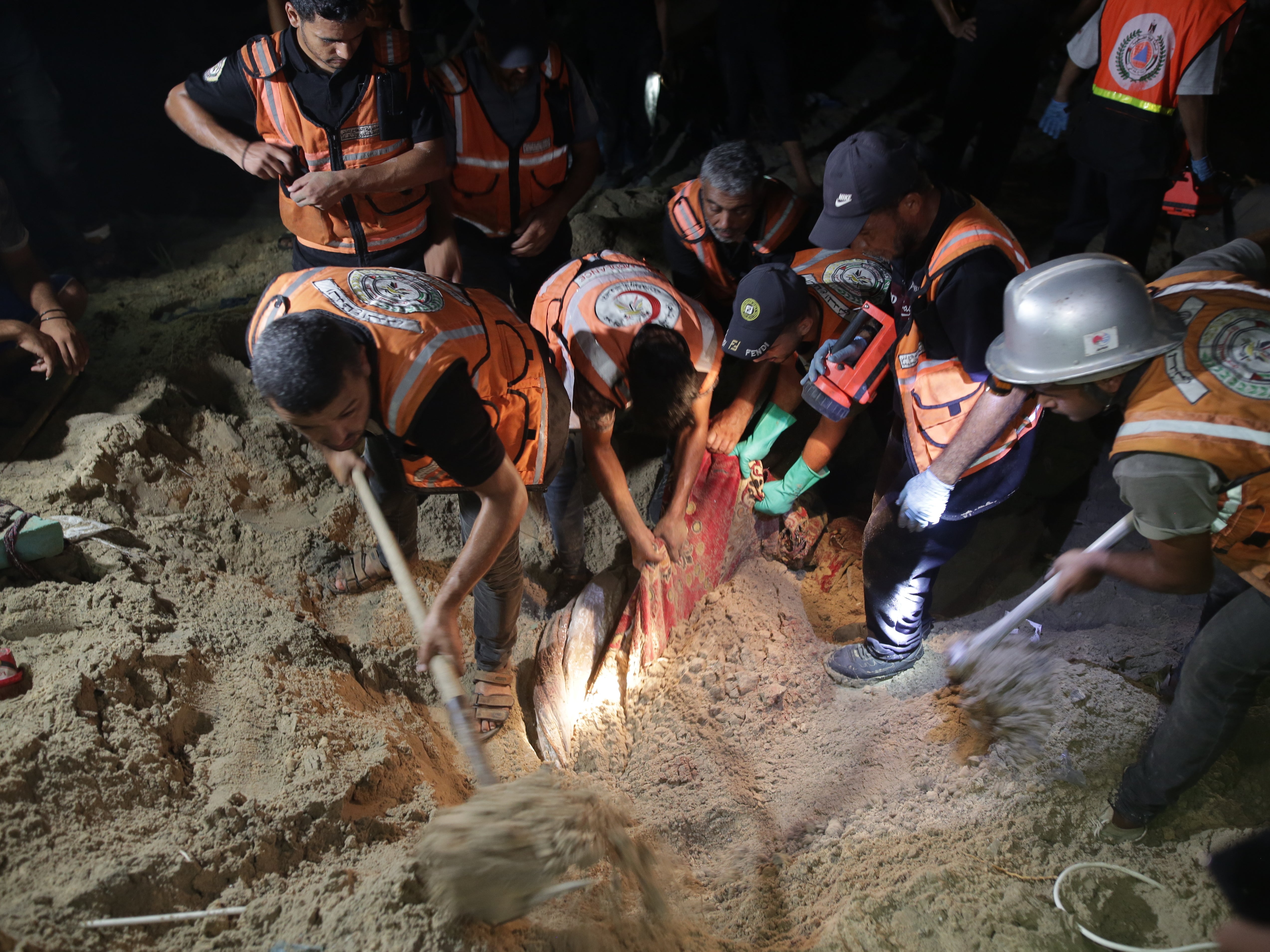 Rescue workers search for survivors after Israeli airstrikes on a tent encampment of displaced Palestinians in al Mawasi area of Khan Yunis, Gaza, on 10 September 2024.