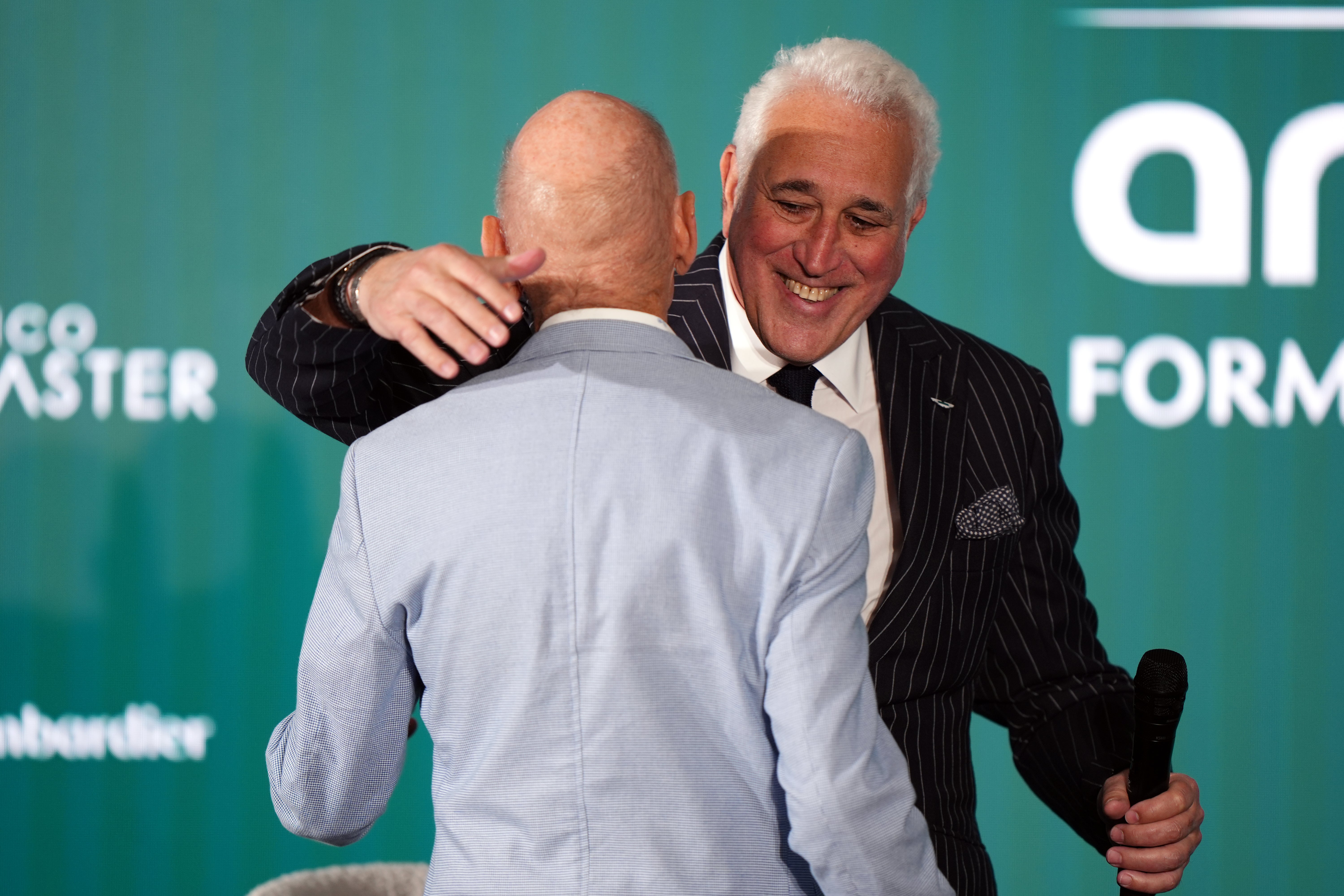 Aston Martin executive chairman Lawrence Stroll embraces Newey at Tuesday’s announcement