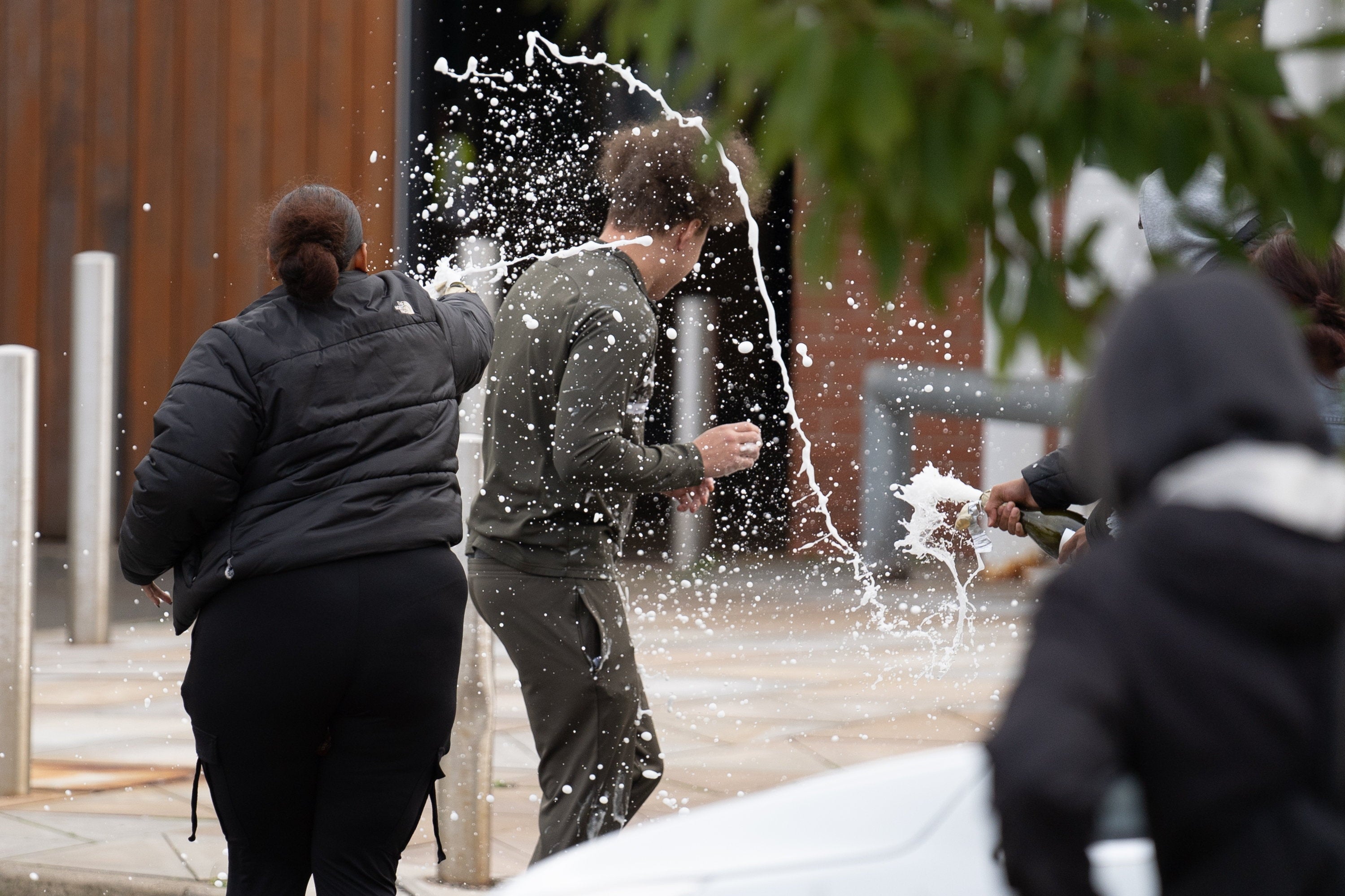 People spray sparkling wine over a man who walked out of Nottingham Prison