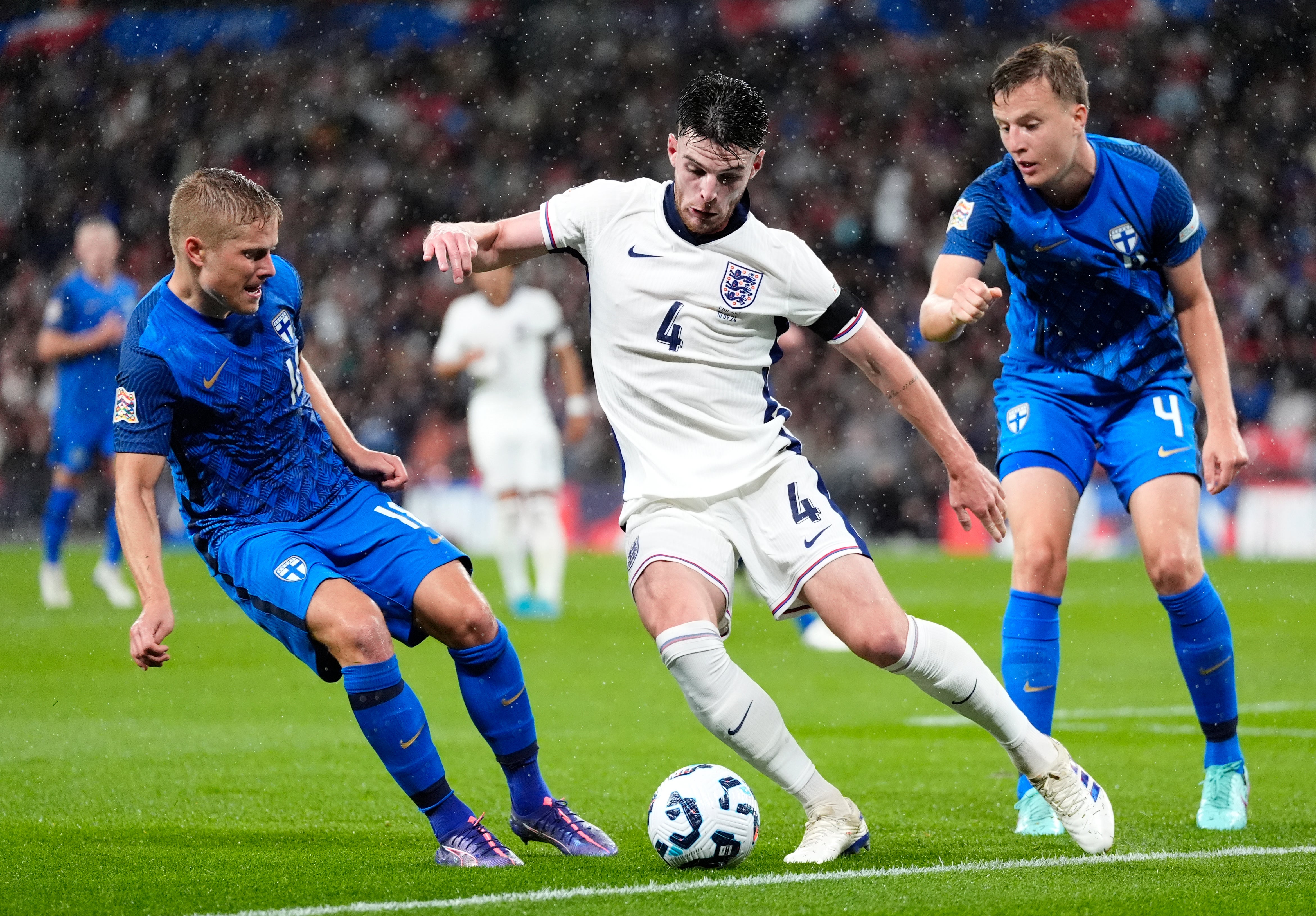 Declan Rice is confronted by Finland players