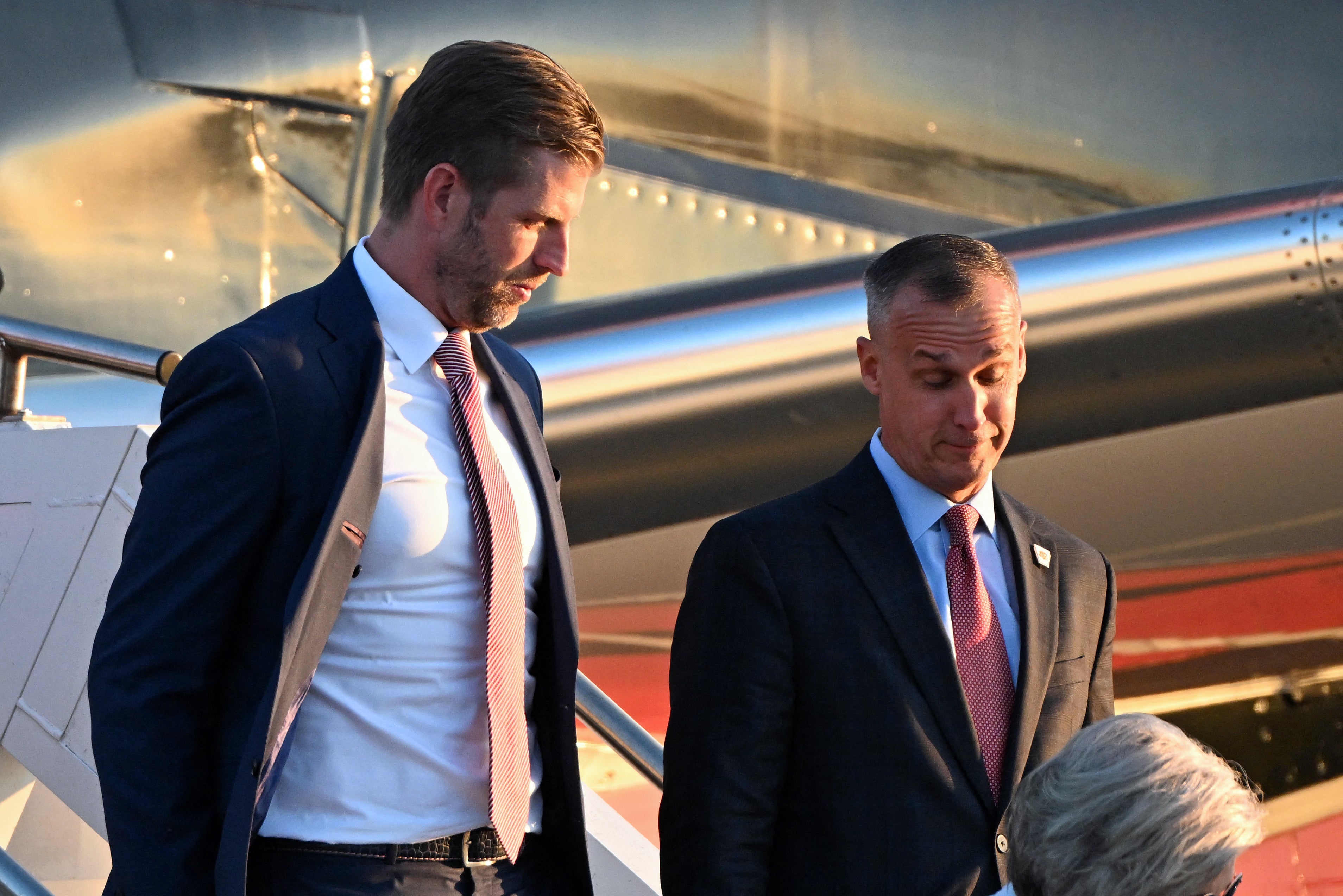 Eric Trump (L) and political operative Corey Lewandowski (R) step off a plane after former US President and Republican presidential candidate Donald Trump upon arrival at Philadelphia International Airport in Philadelphia, Pennsylvania on September 10, 2024