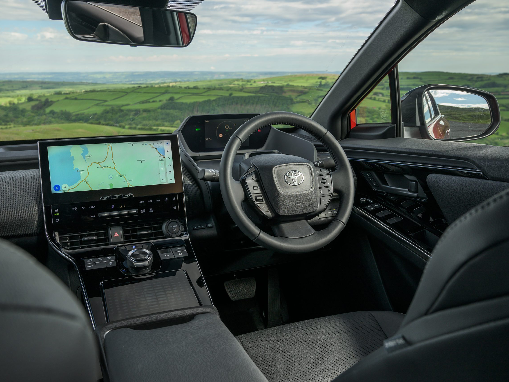 Inside, the Toyota bZ4X features a futuristic interior with a high-mounted touchscreen