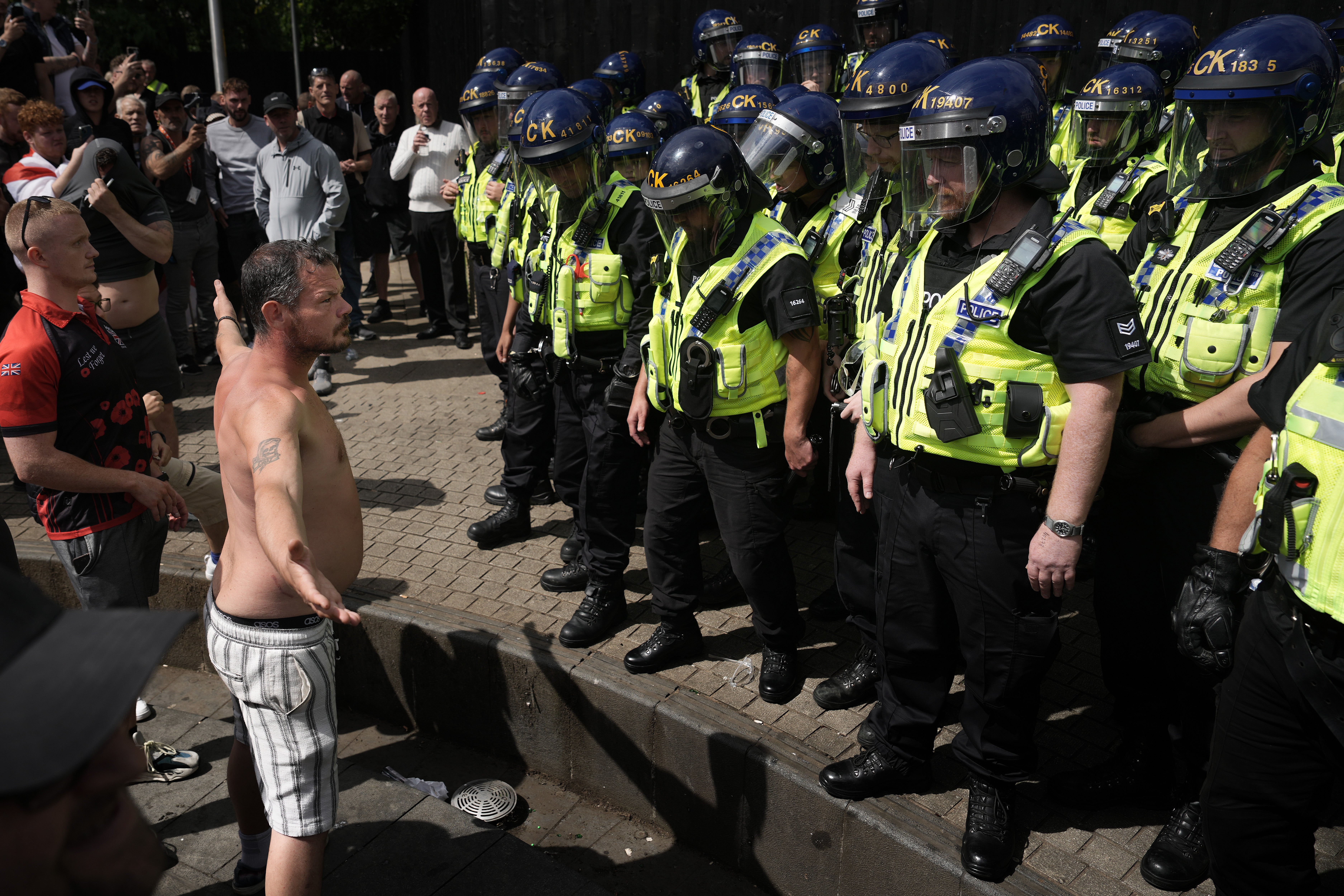 Protesters clash with police in Manchester in August during a summer of riots