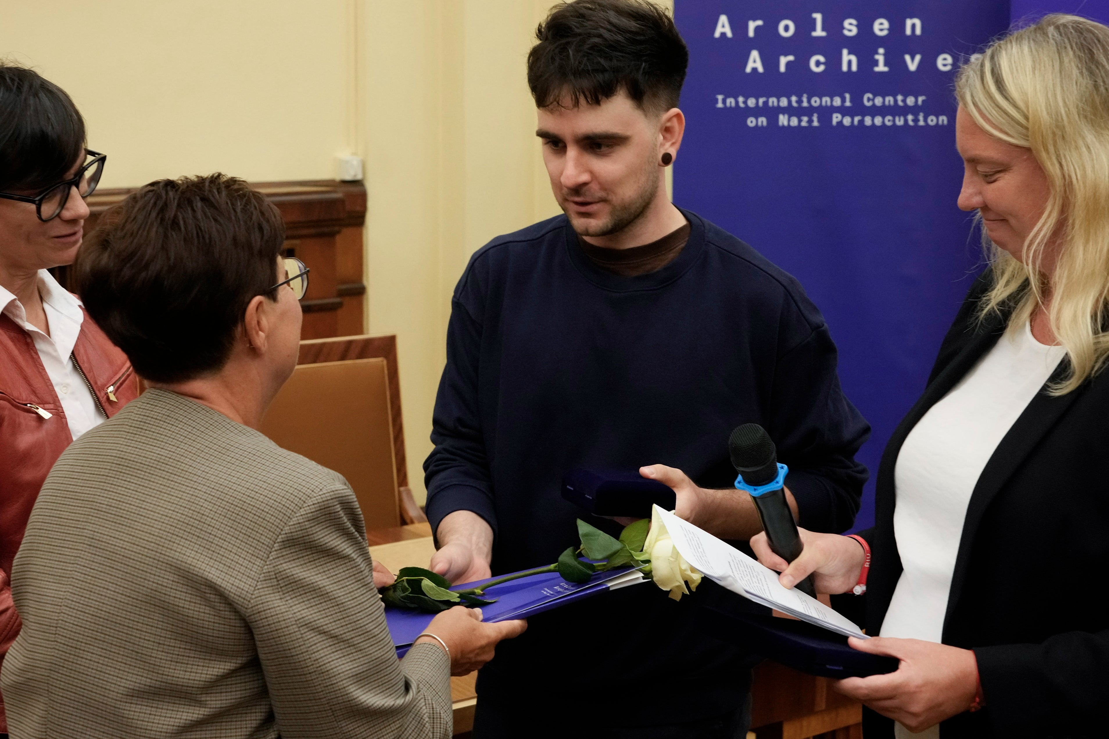 Relatives of the deceased collect their jewellery at the ceremony in Warsaw