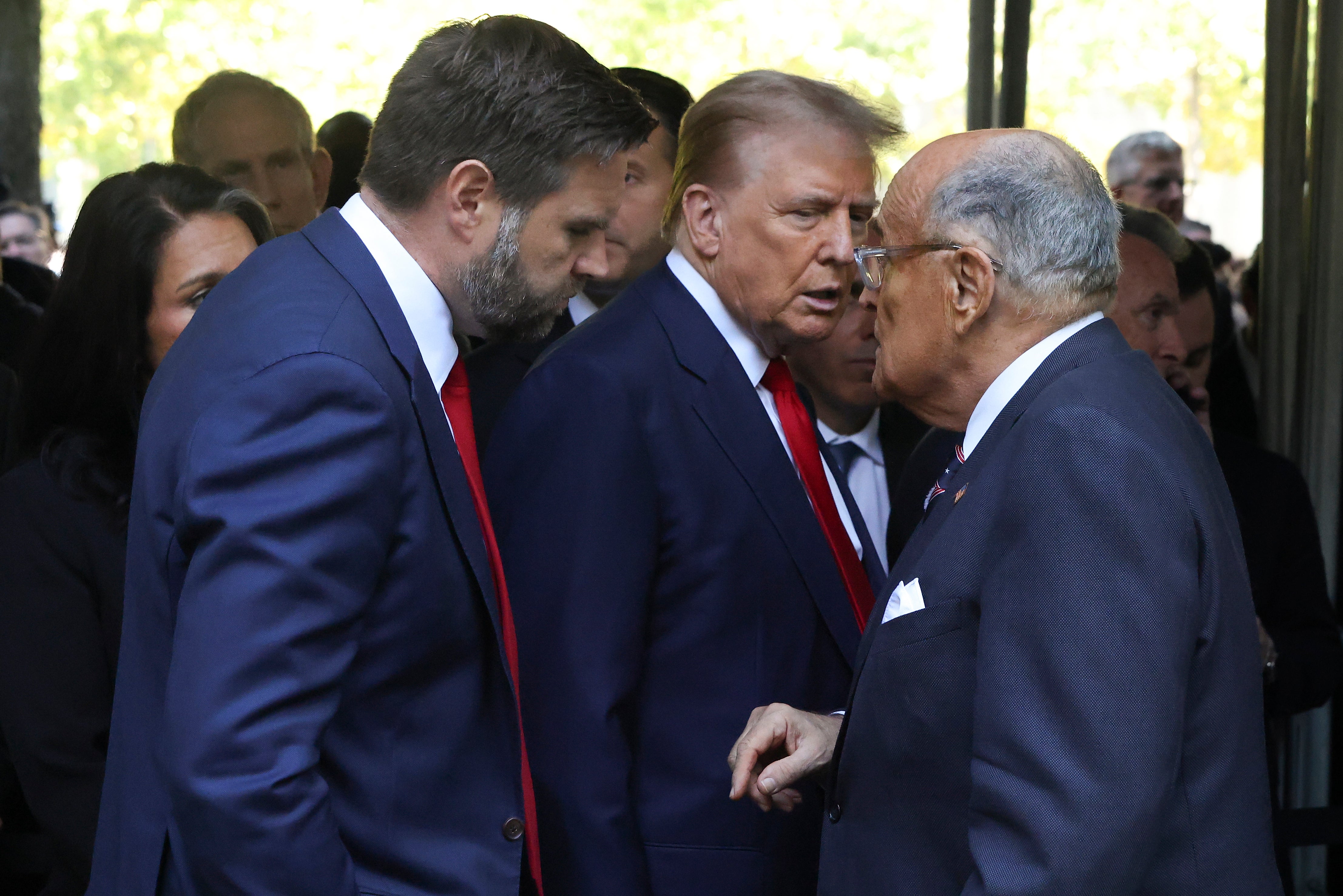 Former New York City Mayor Rudy Giuliani, right, talks with Republican presidential nominee former President Donald Trump, center and Republican vice presidential nominee Sen. JD Vance, R-Ohio, as they depart the 9/11 Memorial ceremony on the 23rd anniversary of the Sept. 11, 2001 terror attacks, Wednesday, Sept. 11, 2024, in New York