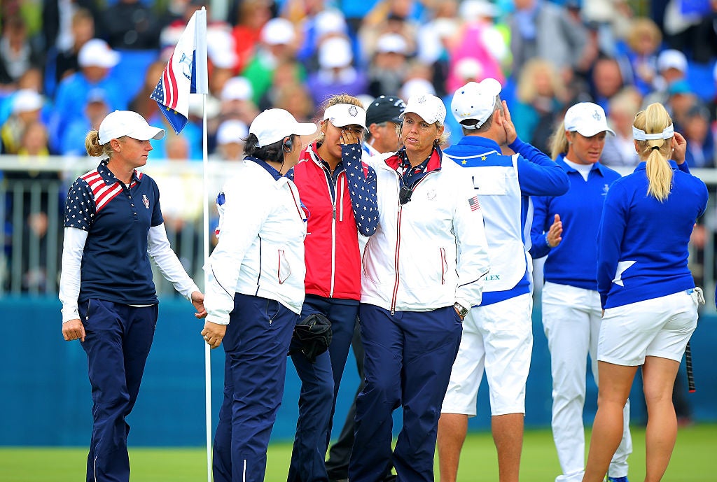 Team USA managers try to console Alison Lee on the 18th green at St Leon-Rot Golf Club, Germany in 2015