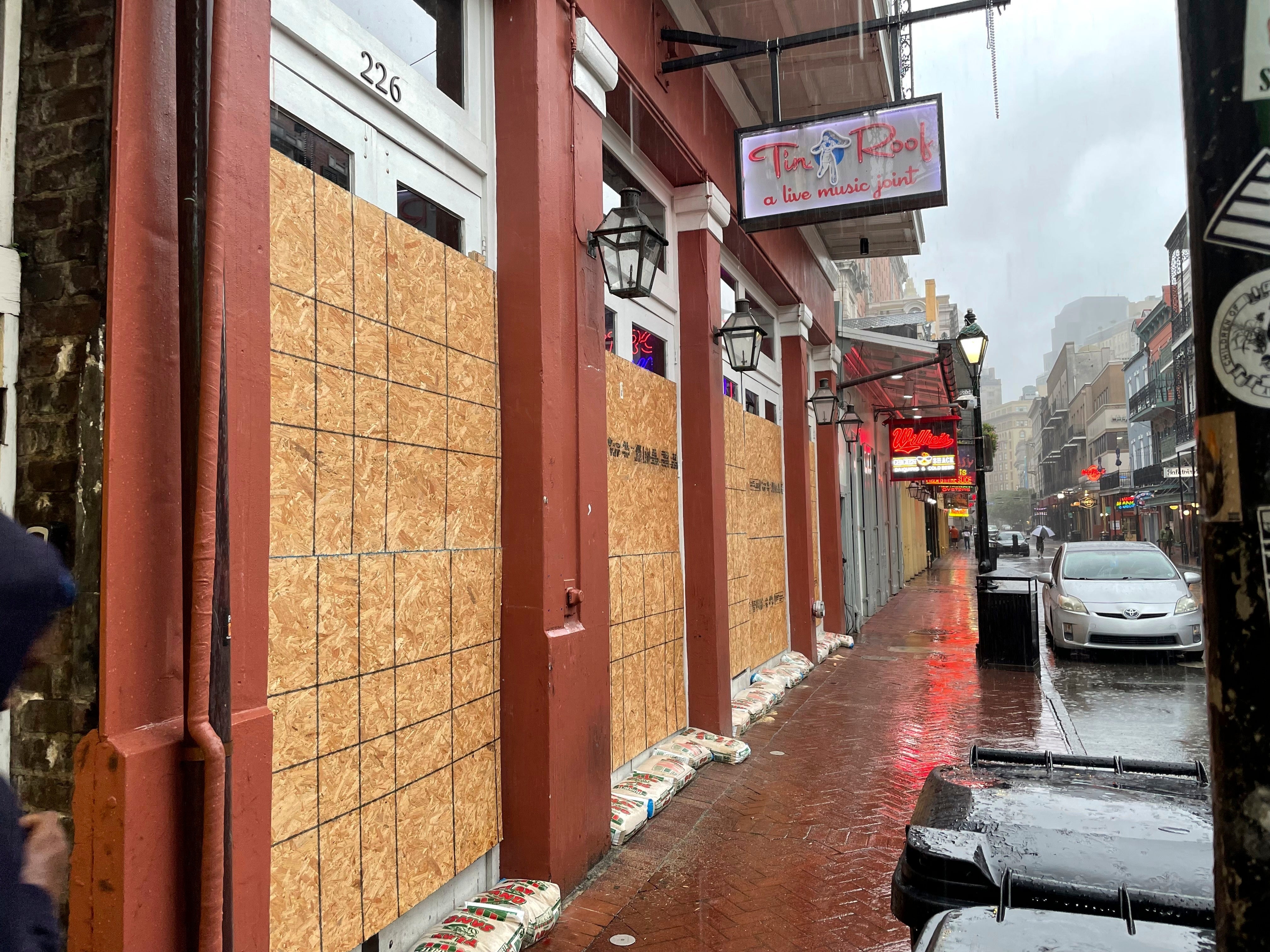 Boards and sandbags cover the windows of a Bourbon Street bar in New Orleans' French Quarter on Wednesday. The city is under a hurricane watch, as the storm barrels toward the Louisiana coast.