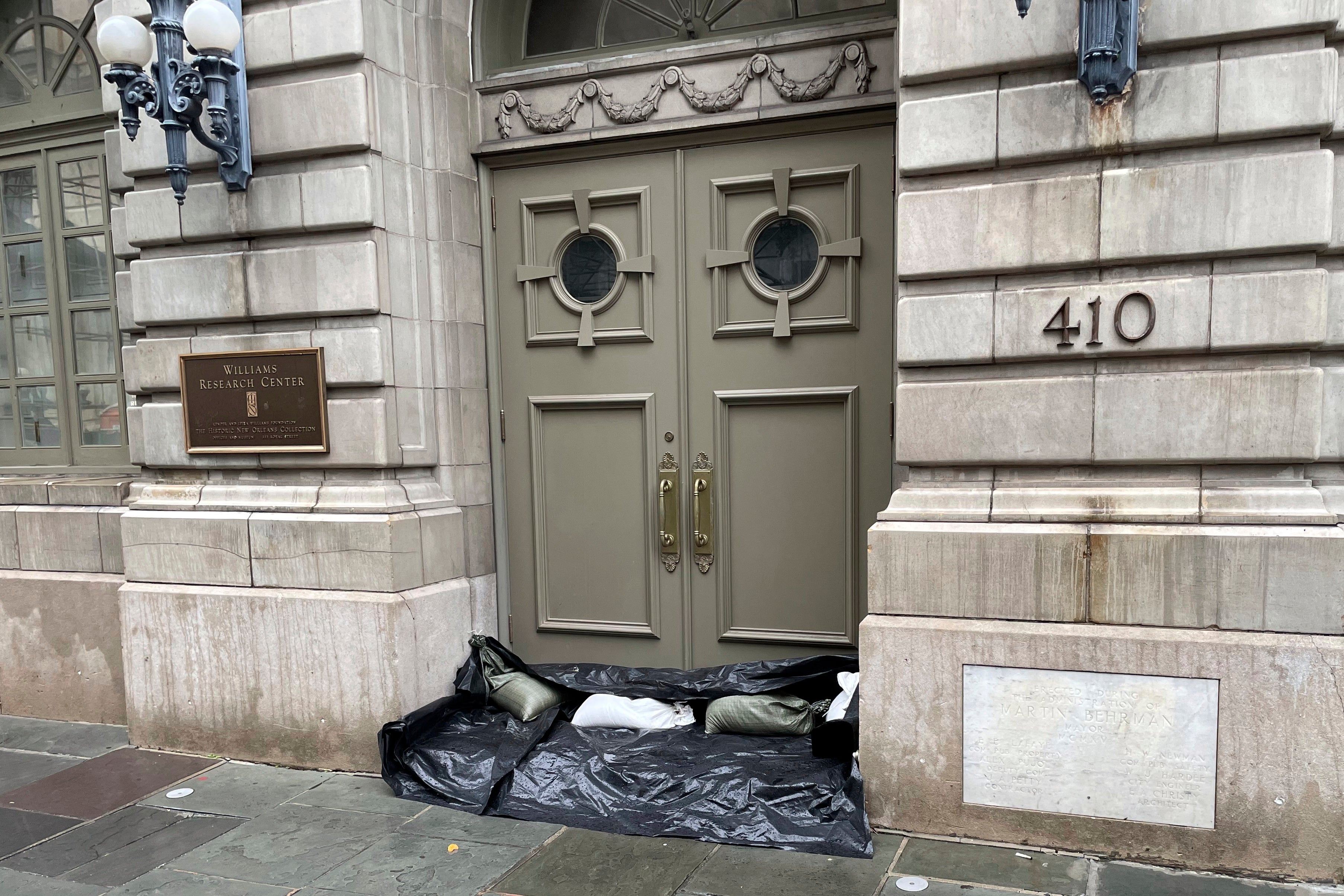 Sandbags and plastic line the entrance to the the Williams Research Center in the New Orleans French Quarter on Wednesday. The city is bracing for Hurricane Francine, which is expected to make landfall in the coming hours. City officials hosted a news conference in preparation for the storm.