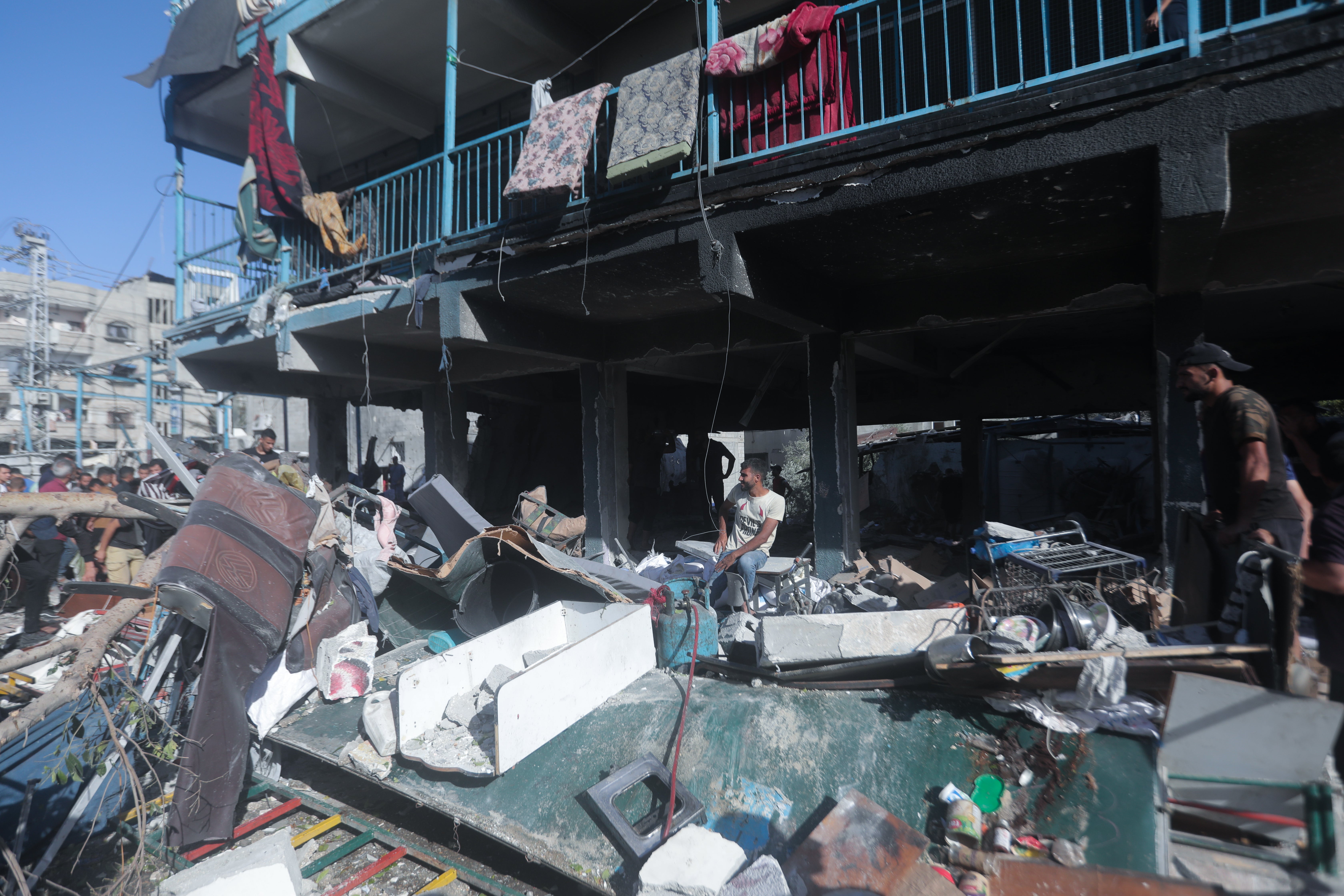 People search for survivors after the airstrike on the school in central Gaza