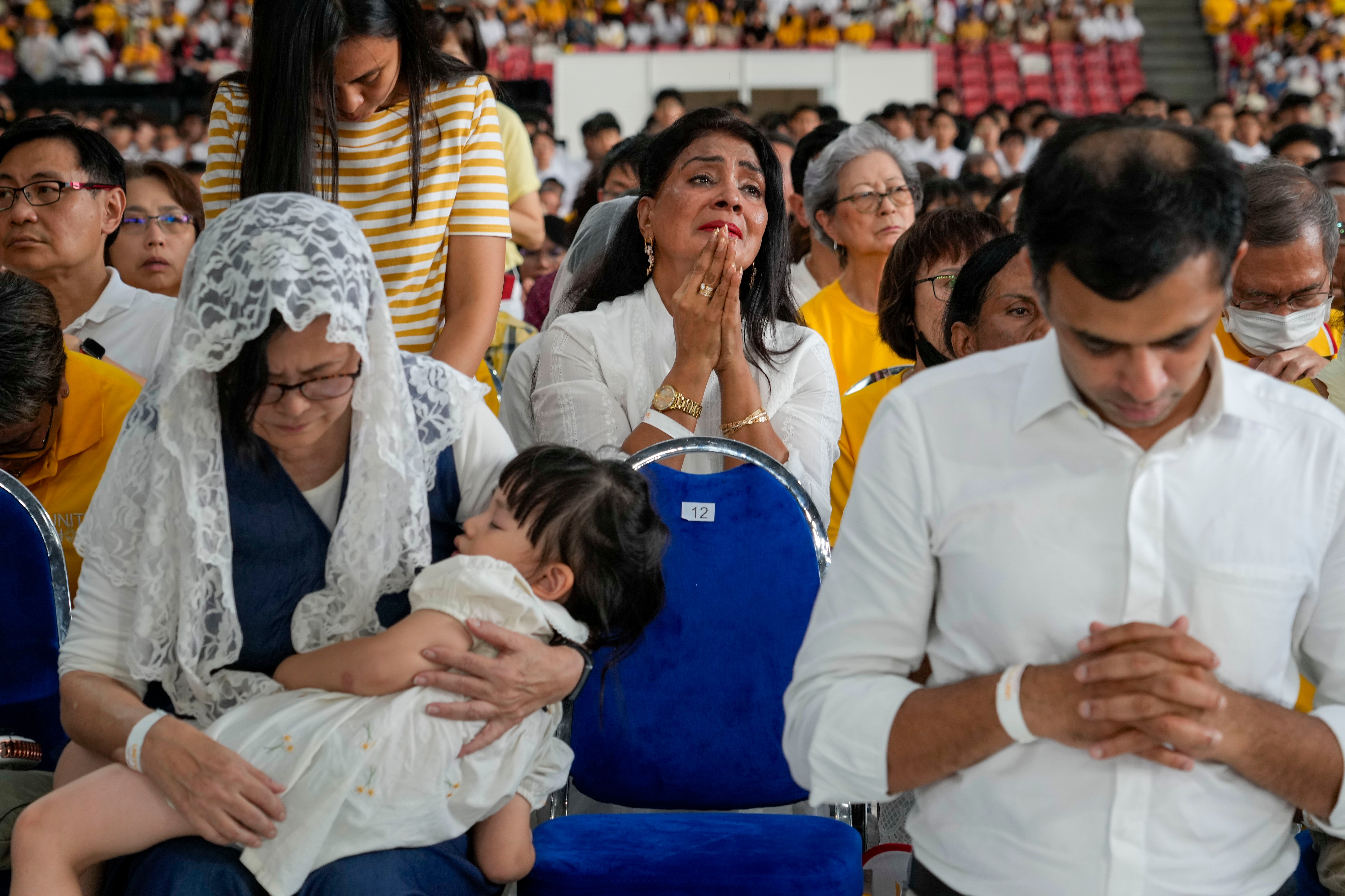 Christians follow Pope Francis presiding over a mass 'In Memory of the Most Holy Name of Mary' celebrated by the Archbishop of Singapore on 12 September 2024