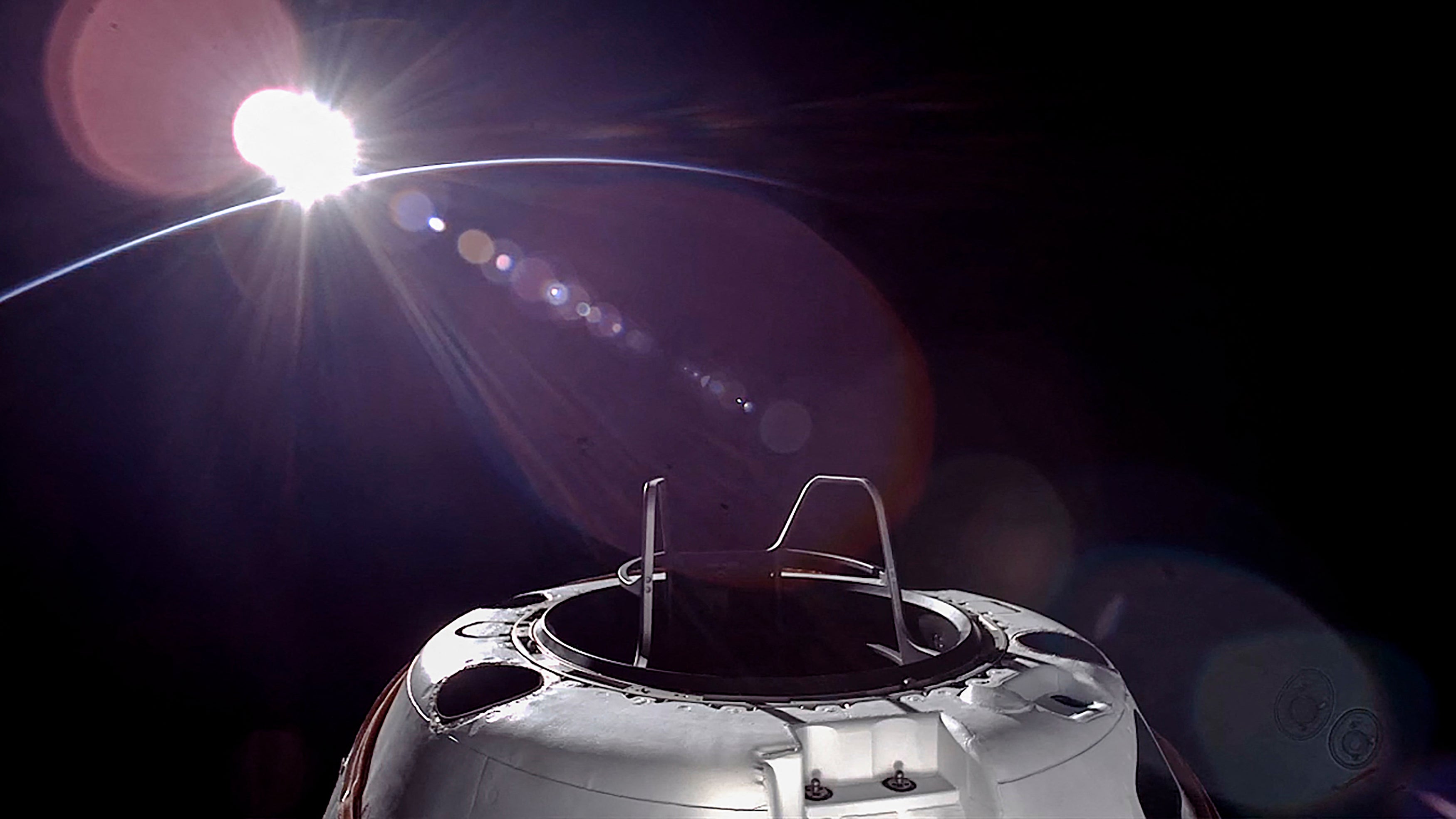 This handout picture courtesy of SpaceX and Polaris taken on September 12, 2024, shows an orbital sunset from the SpaceX Dragon capsule with a hatch structure called "Skywalker", ahead of the first private spacewalk performed by the crew of the SpaceX Polaris Dawn mission