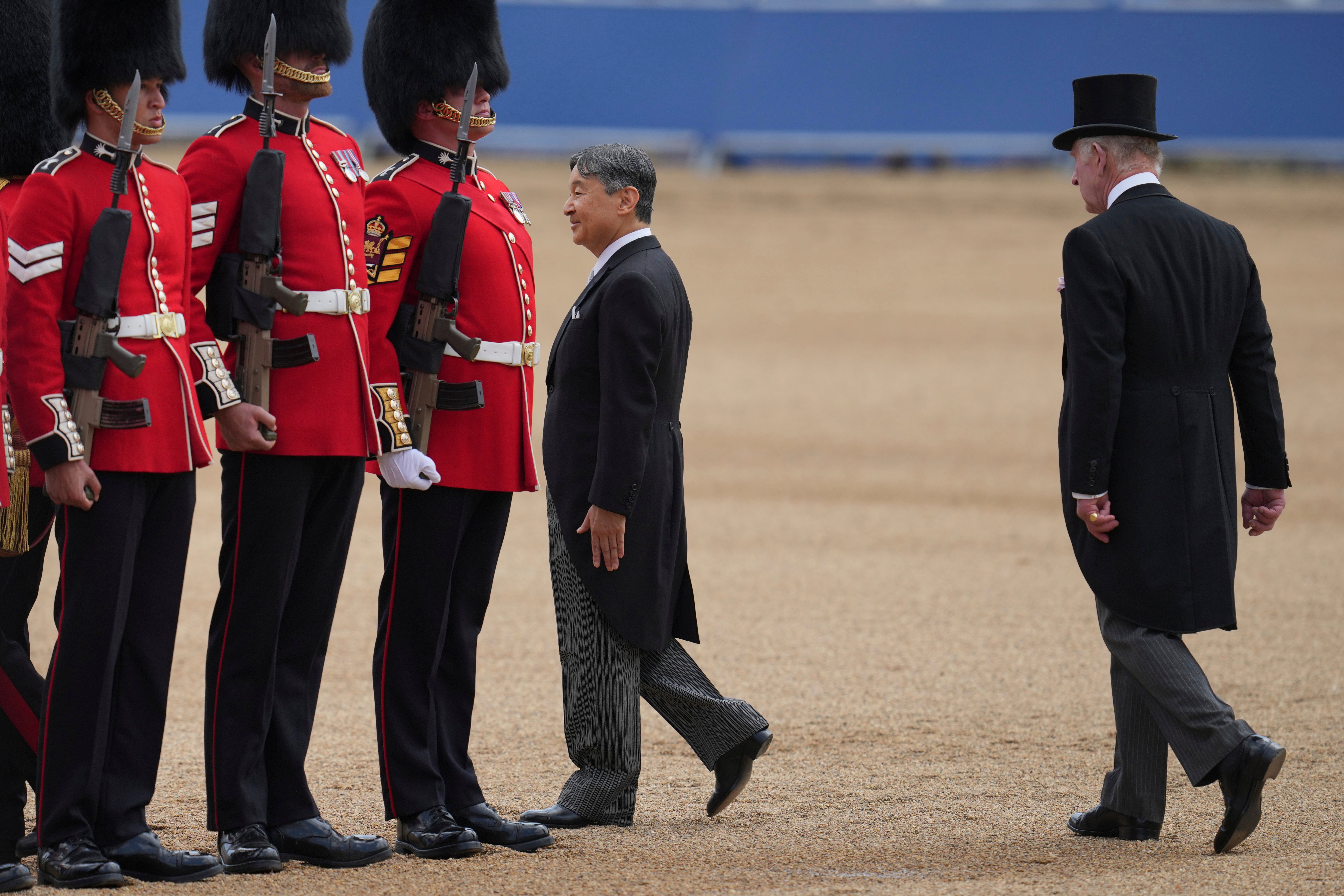 Japan’s Emperor Naruhito, escorted by Britain’s King Charles III inspect the honour guard