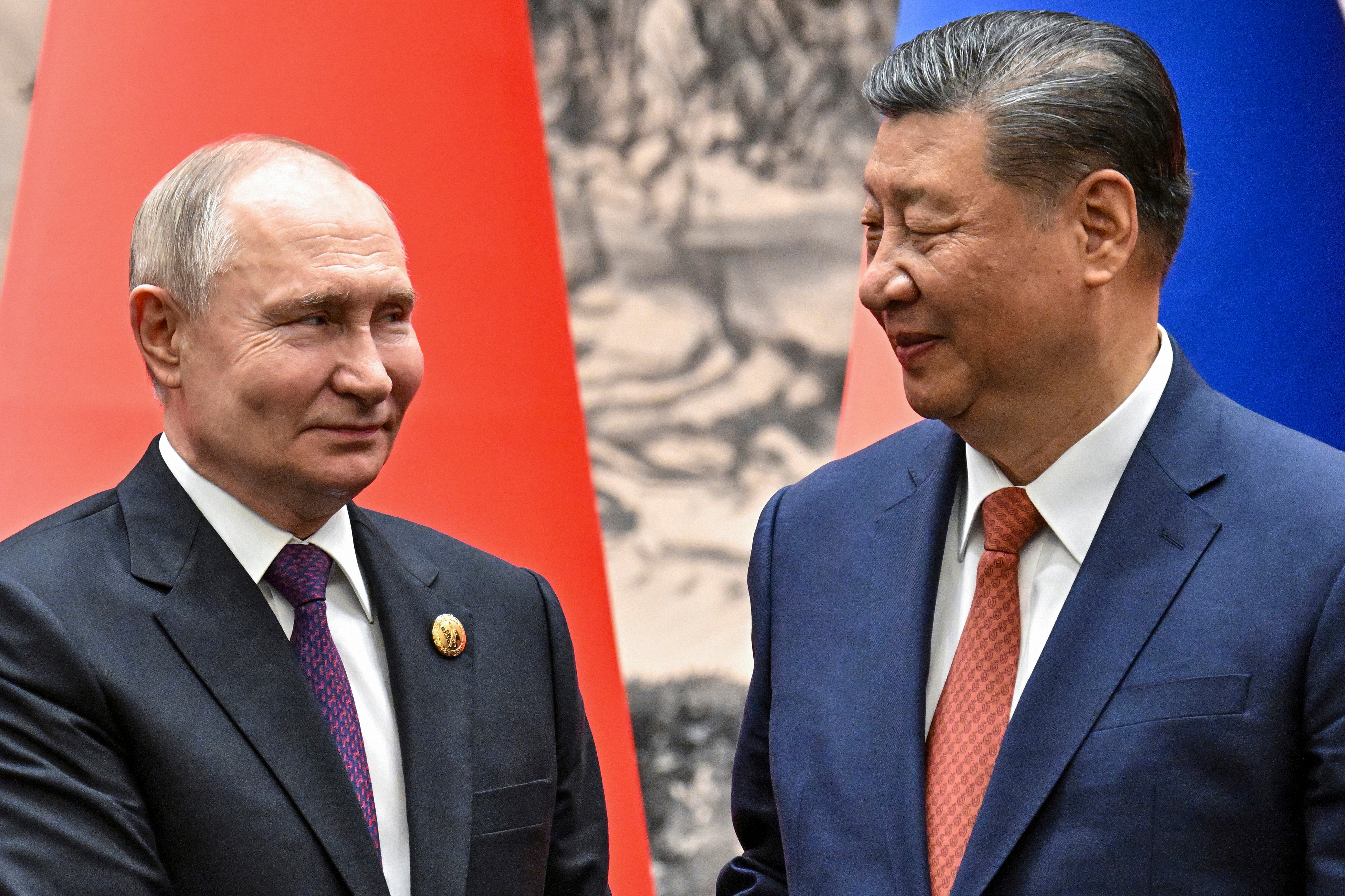 Chinese president Xi Jinping and Russian president Vladimir Putin shake hands prior to their talks in Beijing on 16 May