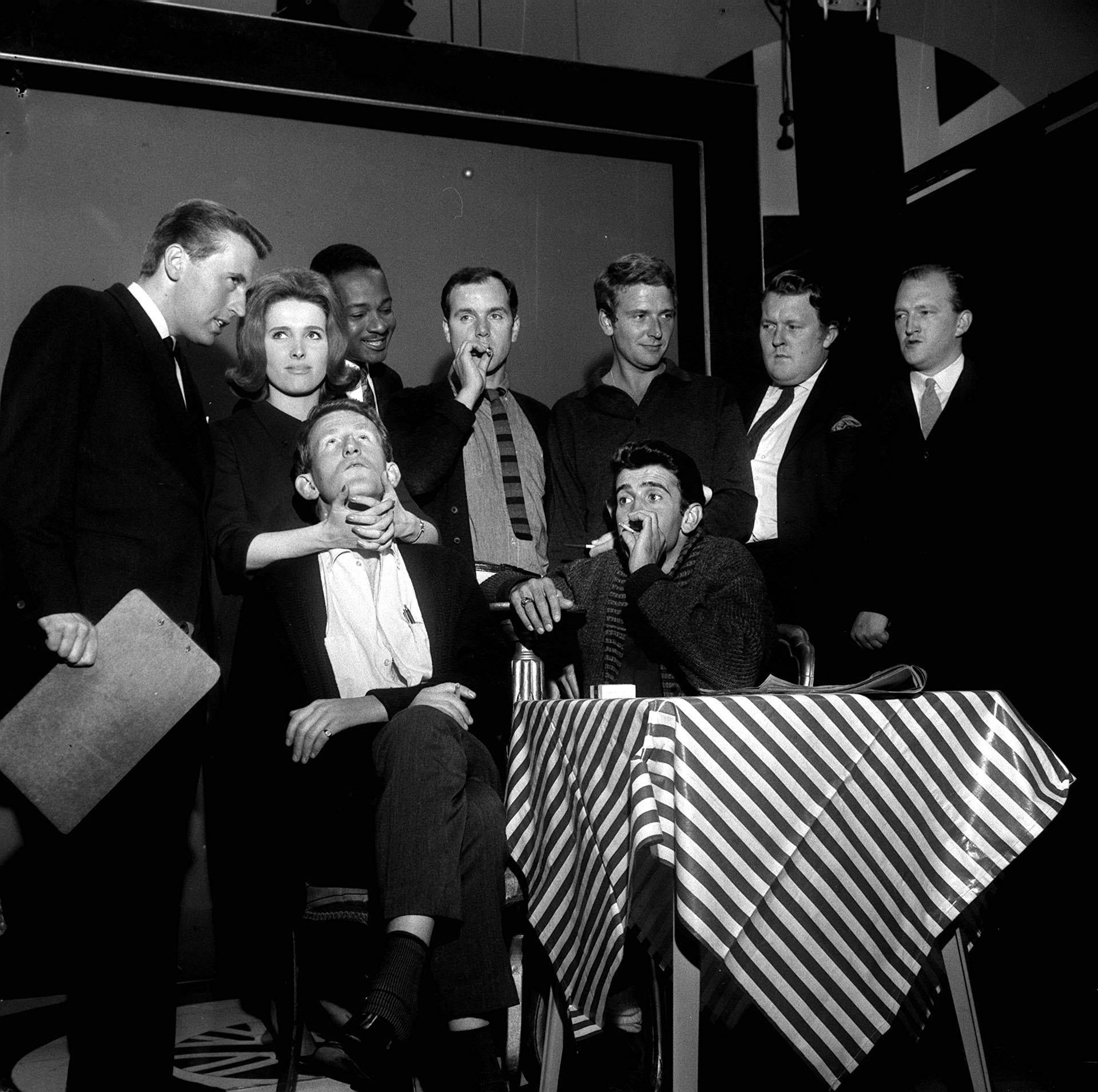 The cast of That Was The Week That Was (left to right, standing) David Frost, Millicent Martin, Irwin C Watson, Kenneth Cope, David Kernan, William Rushton and Robert Lang, and (seated) Lance Percival and Al Mancini (PA)