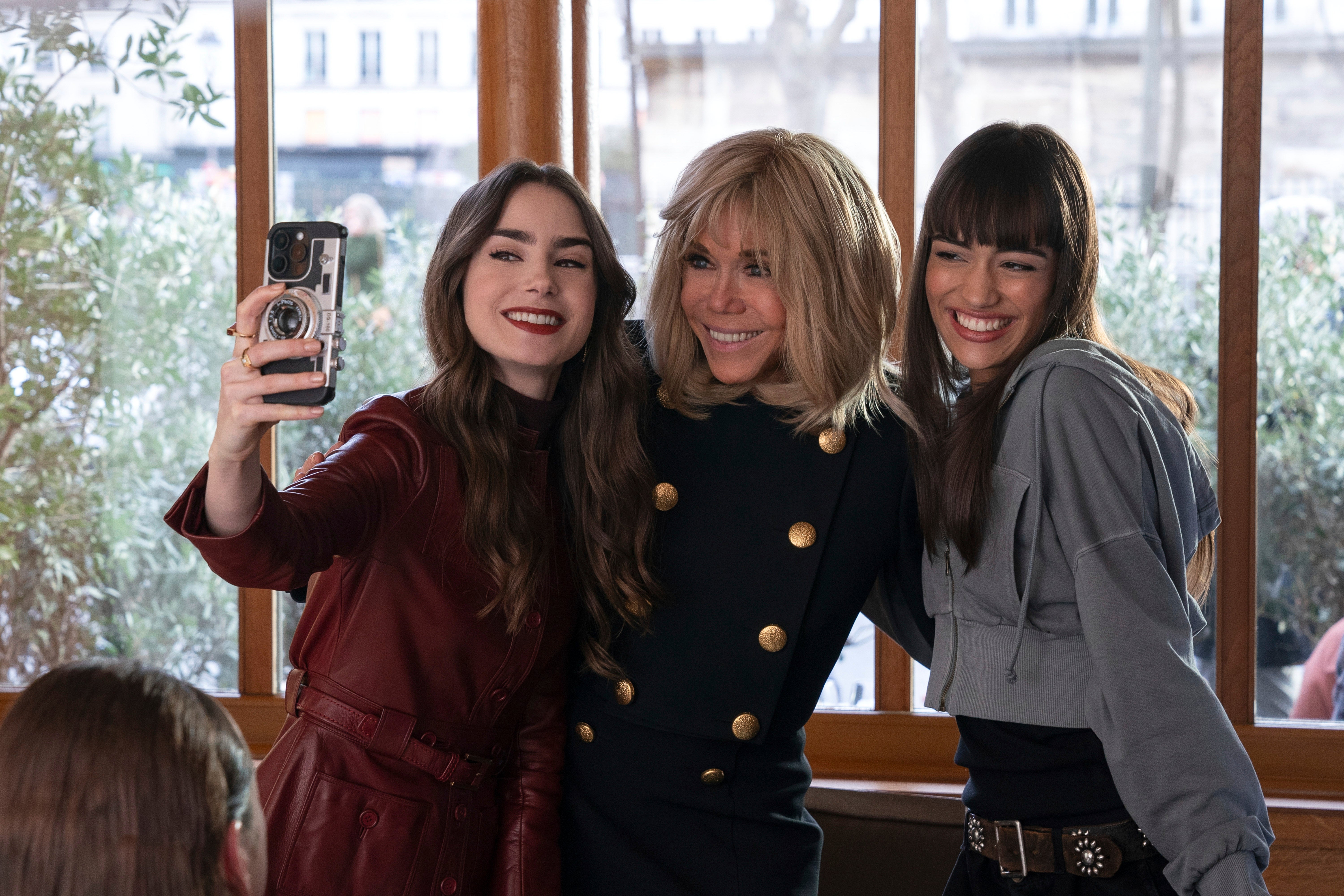 Lily Collins, Brigitte Macron, and Thalia Besson in Emily in Paris