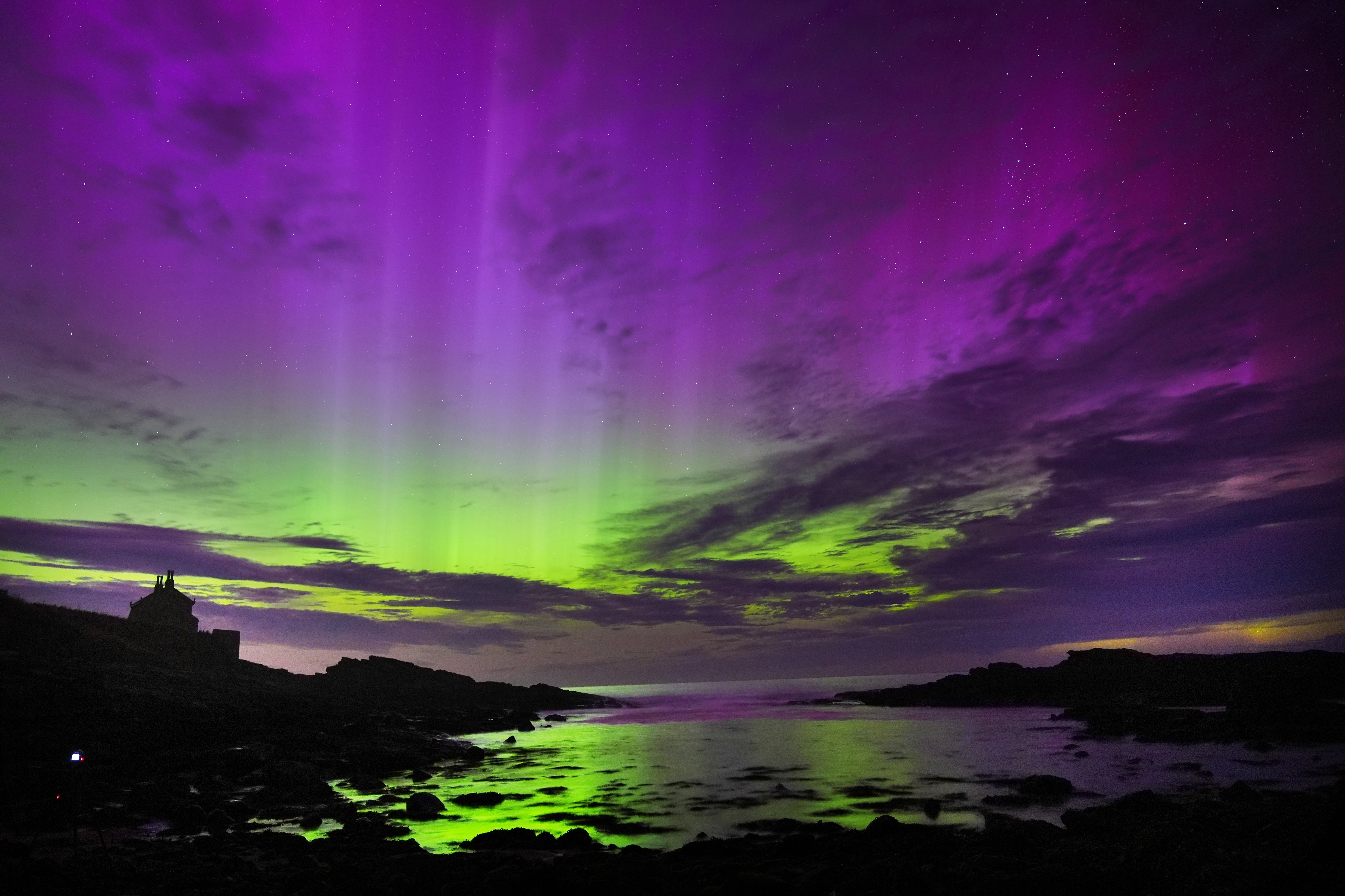 Aurora borealis, also known as the northern lights, fill the sky over The Bathing House in Howick, Northumberland in August (Owen Humphreys/PA)