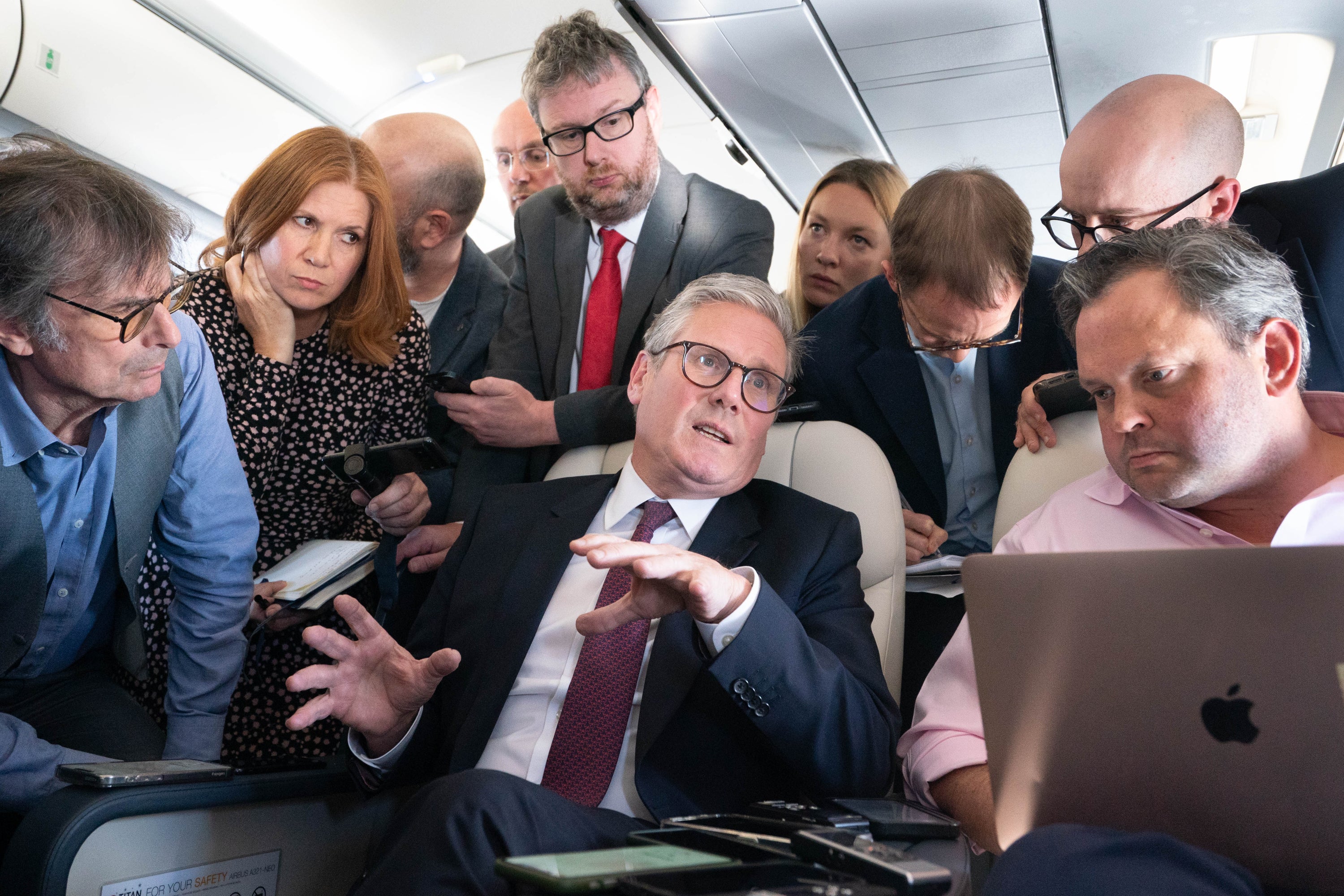 Sir Keir Starmer talks to the media on board his plane as he flies to Washington DC (Stefan Rousseau/PA)