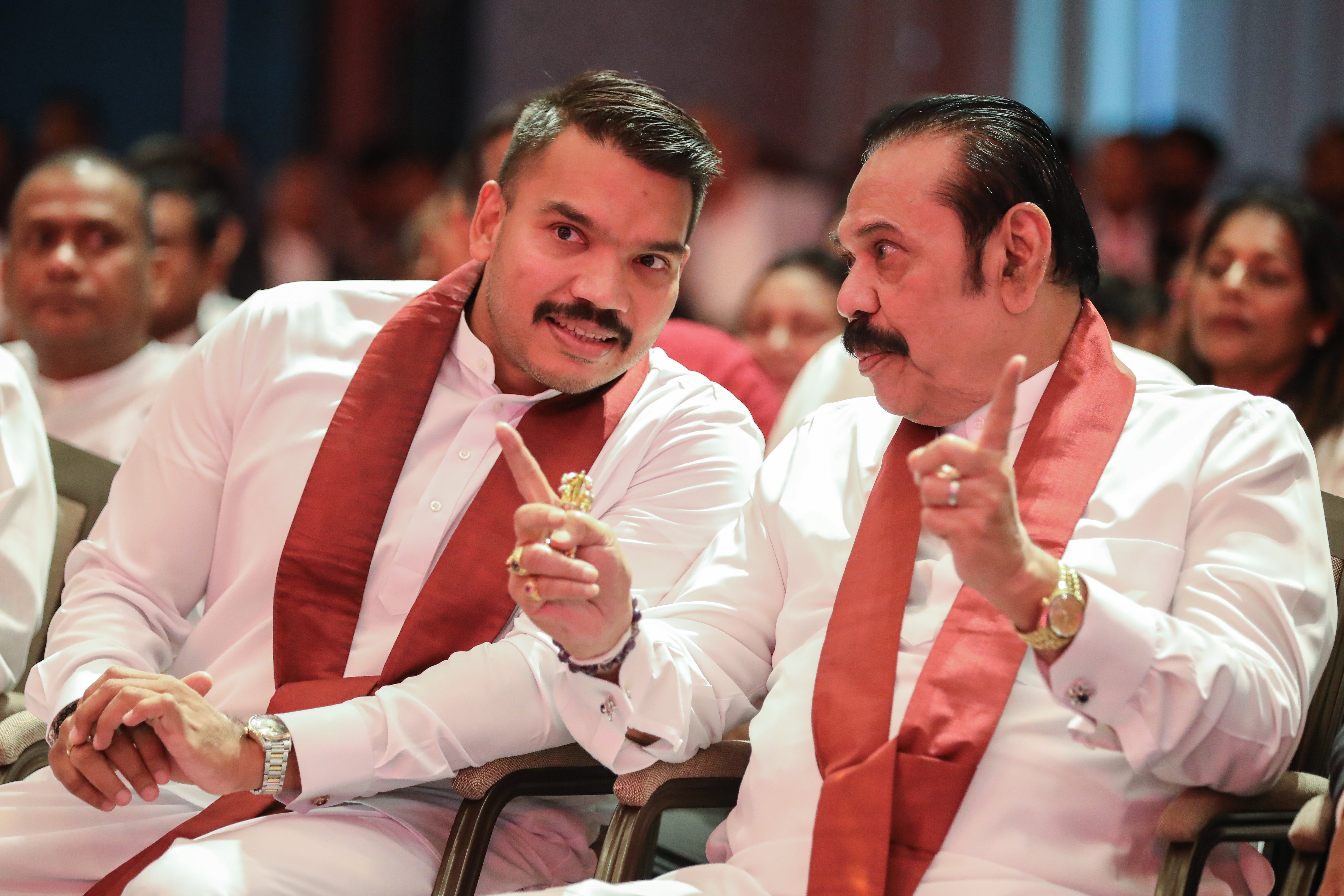 Namal Rajapaksa (L), presidential candidate for the SLPP party, discusses his manifesto with his father, former Sri Lankan president Mahinda Rajapaksa (R), at an event in Colombo