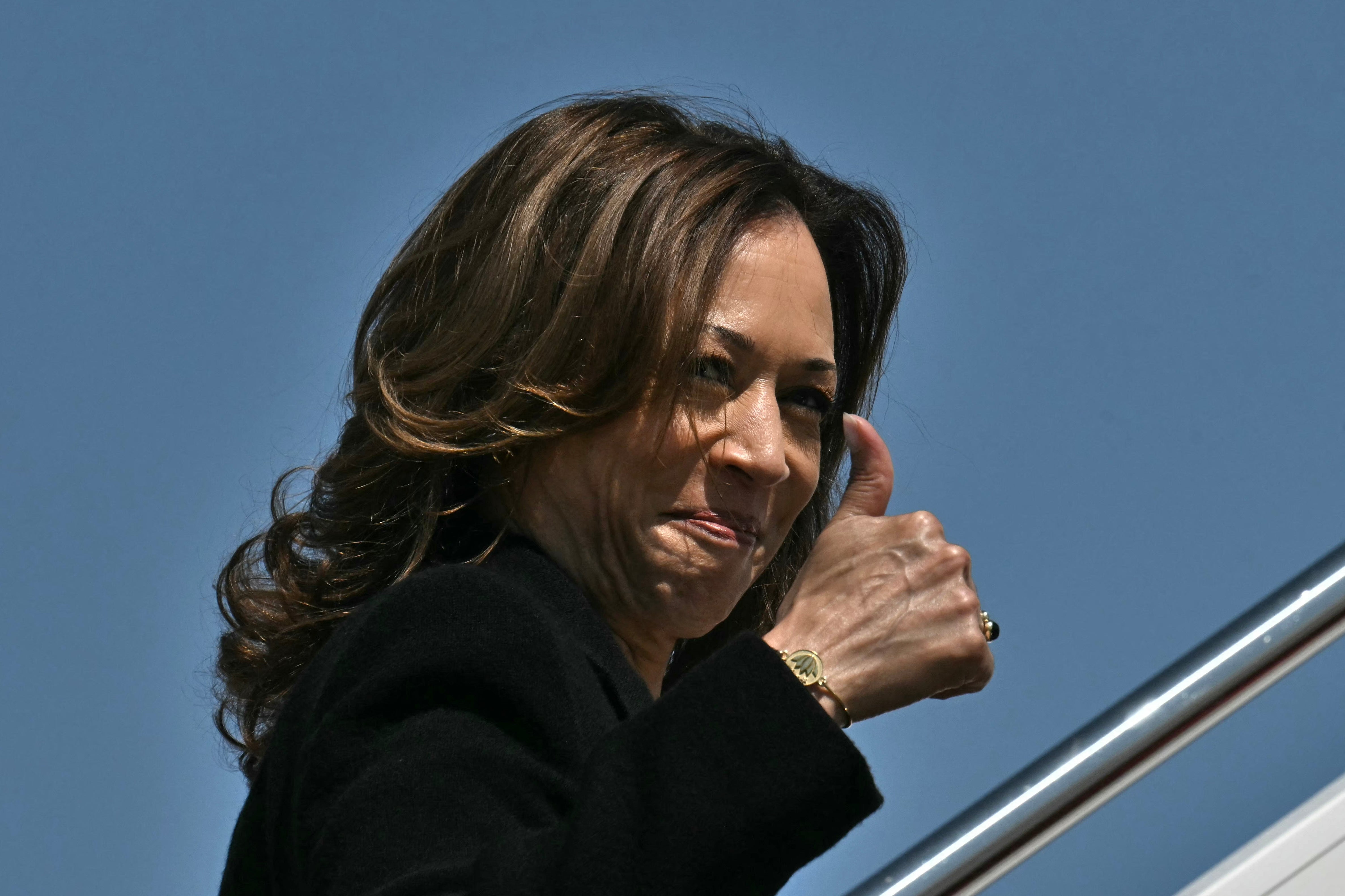 US Vice President and Democratic presidential candidate Kamala Harris gives a thumbs up as she boards Air Force Two at Joint Base Andrews in Maryland on September 12, 2024. The vice president is seeing a lead in the betting markets, which has often predicted the correct winner