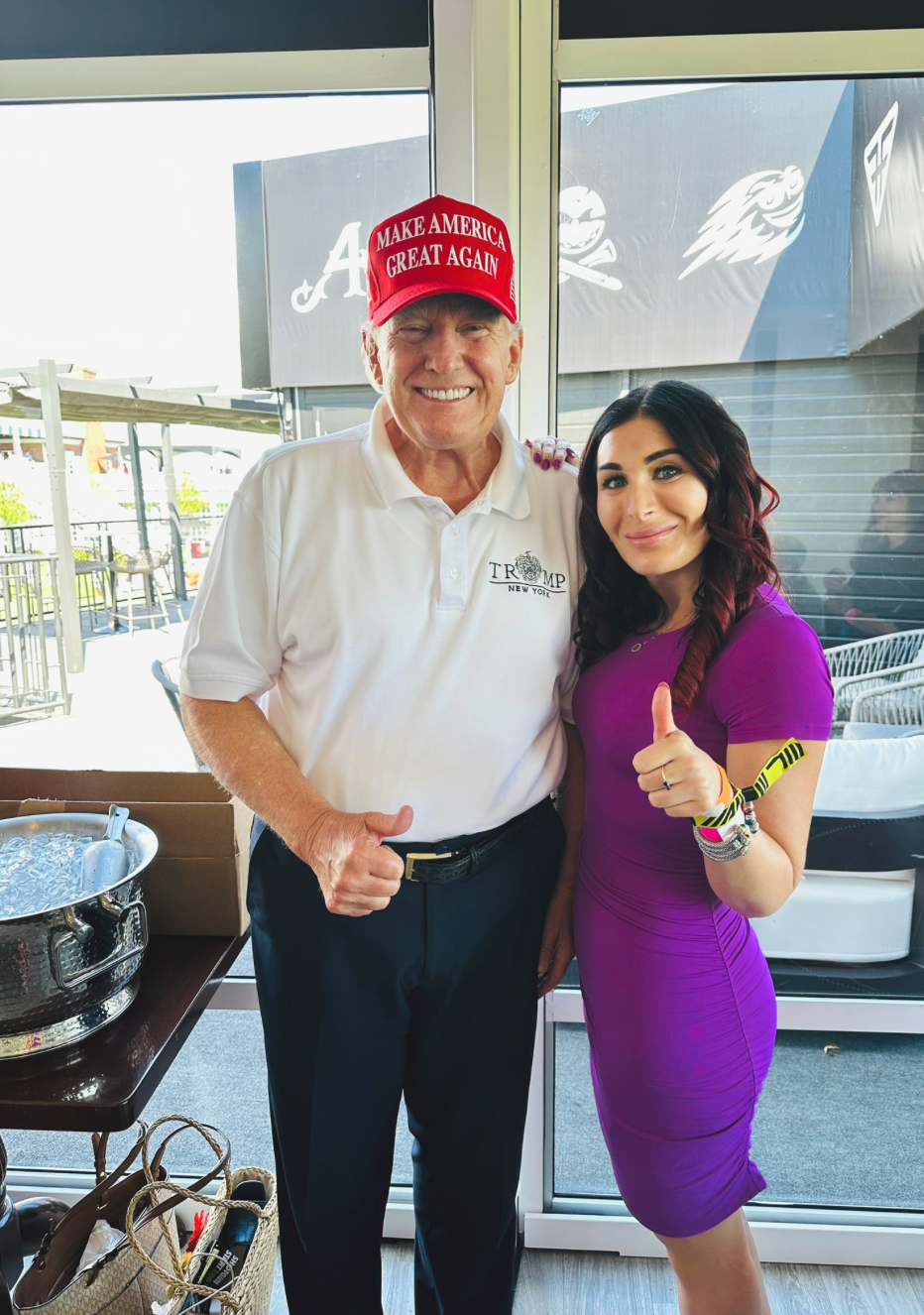 Donald Trump and Laura Loomer smile at the LIV Golf event in August 2023