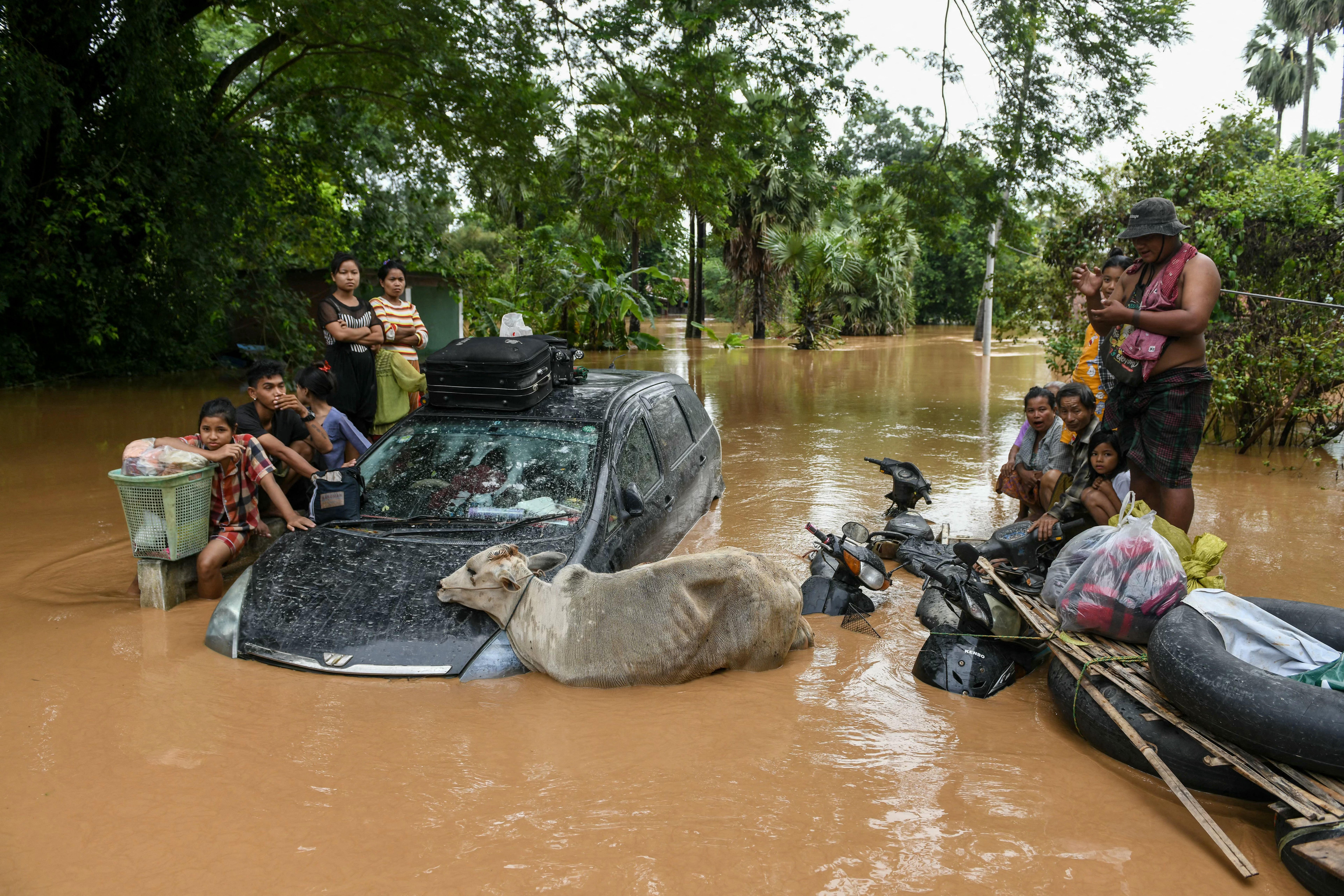 Flood-affected residents wait for a rescue boat to arrive in Taungoo, Myanmar's Bago region