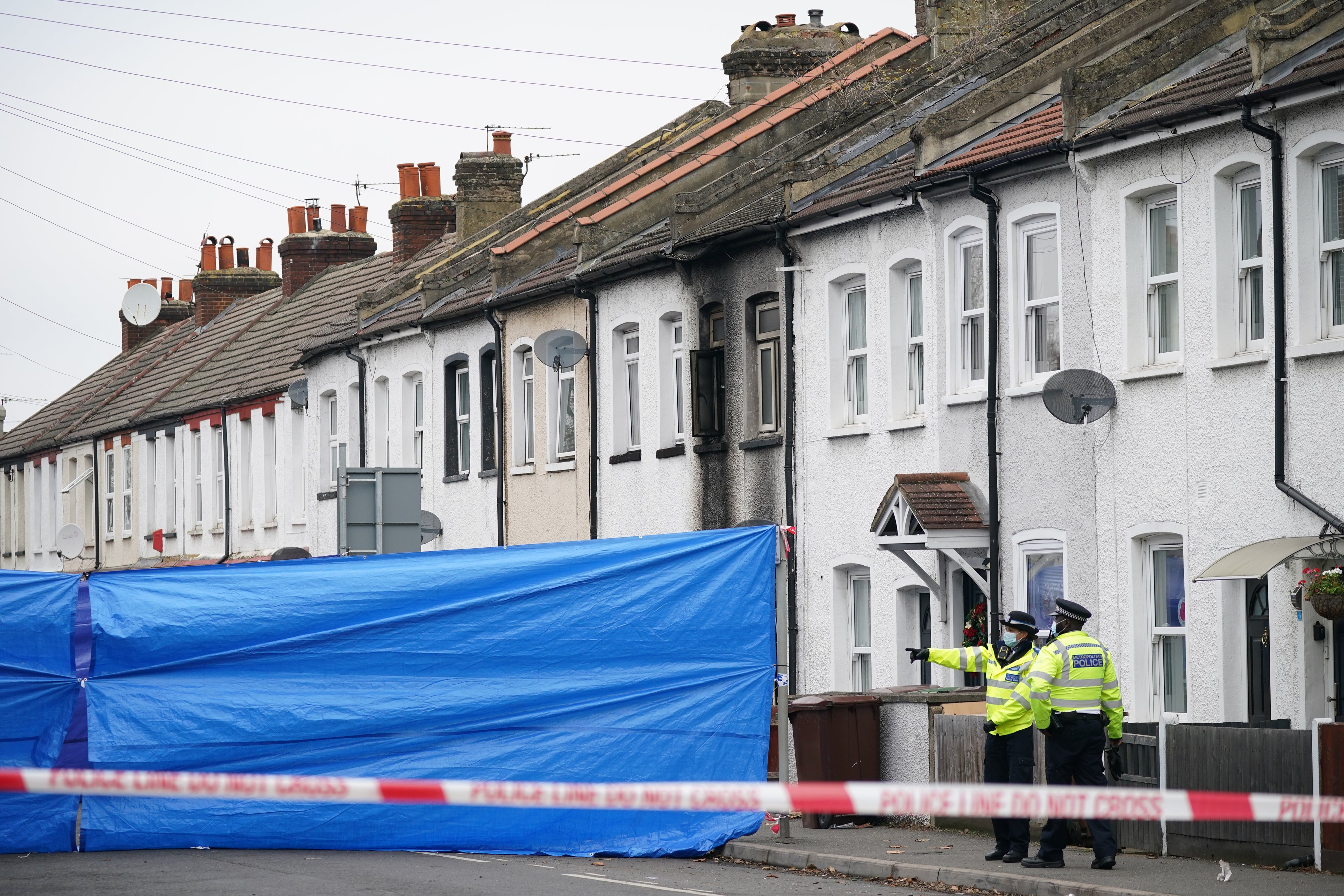 Police at the scene in Collingwood Road, Sutton, south London, where two sets of twin boys, aged three and four, died in a house fire (Yui Mok/PA)