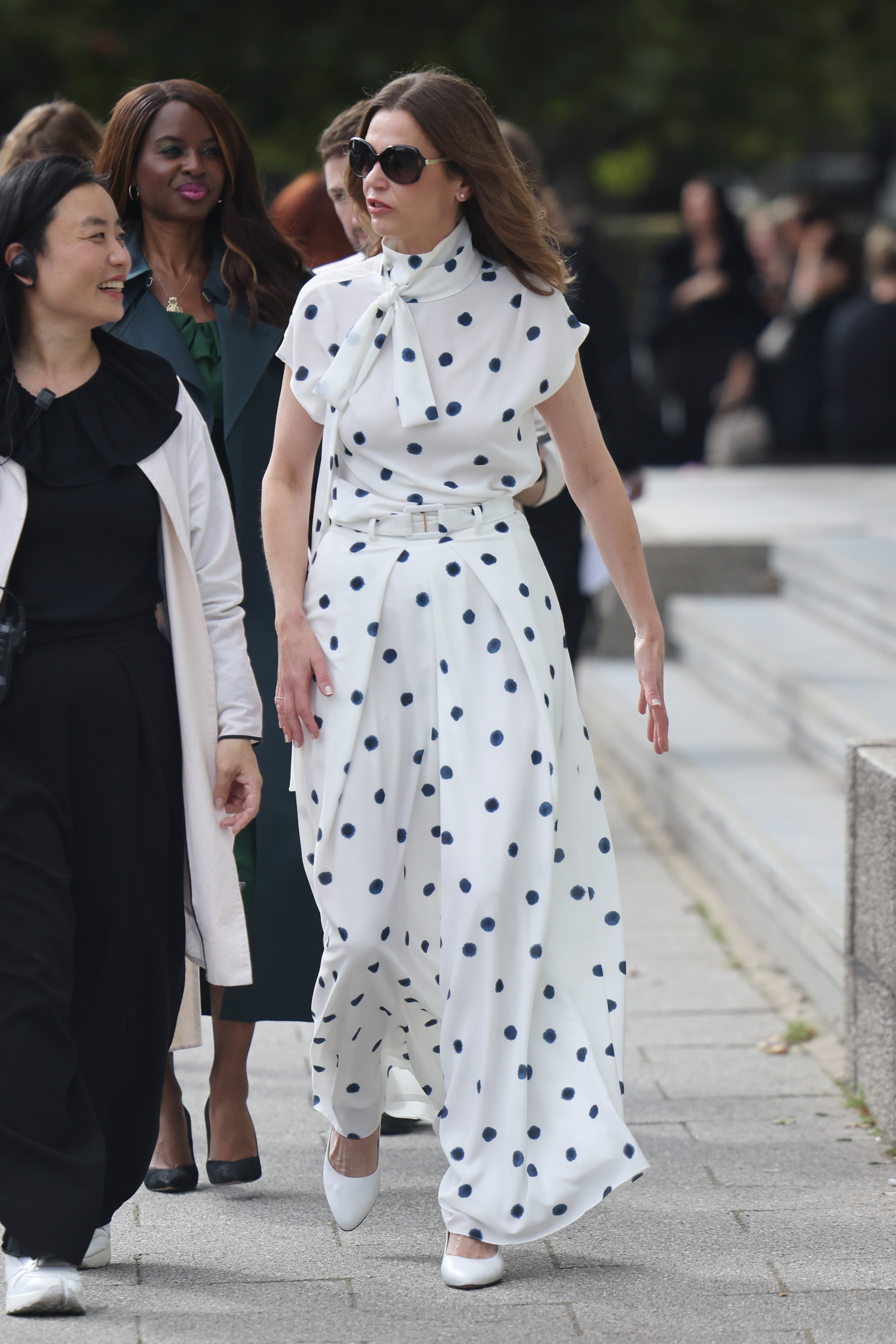 Victoria Starmer (in a white spotty dress and blue jacket) at Edeline Lee at Millbank Tower during London Fashion Week