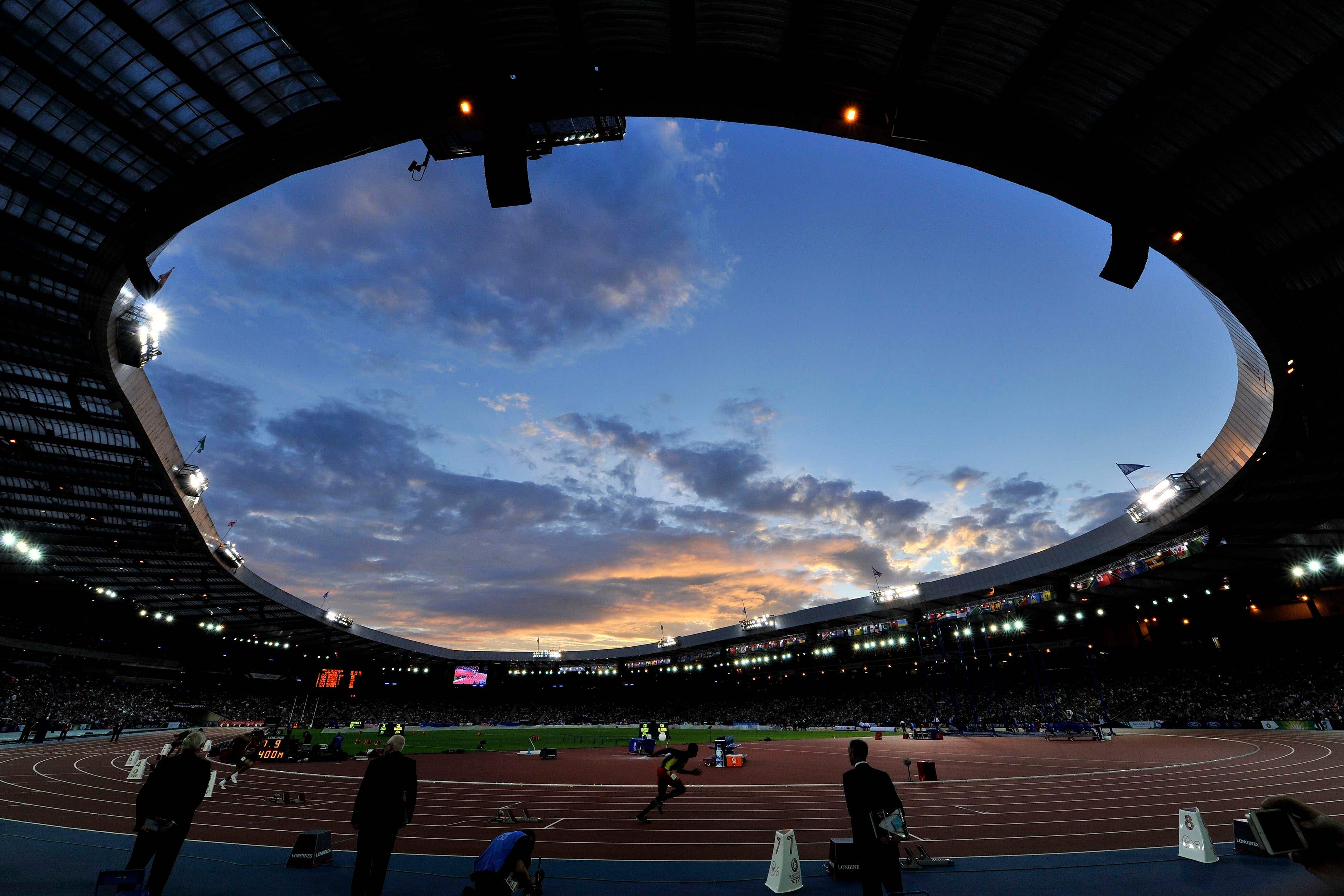 A general view of the sun setting as the athletics takes place at Hampden Park during the 2014 Games (John Giles/PA)