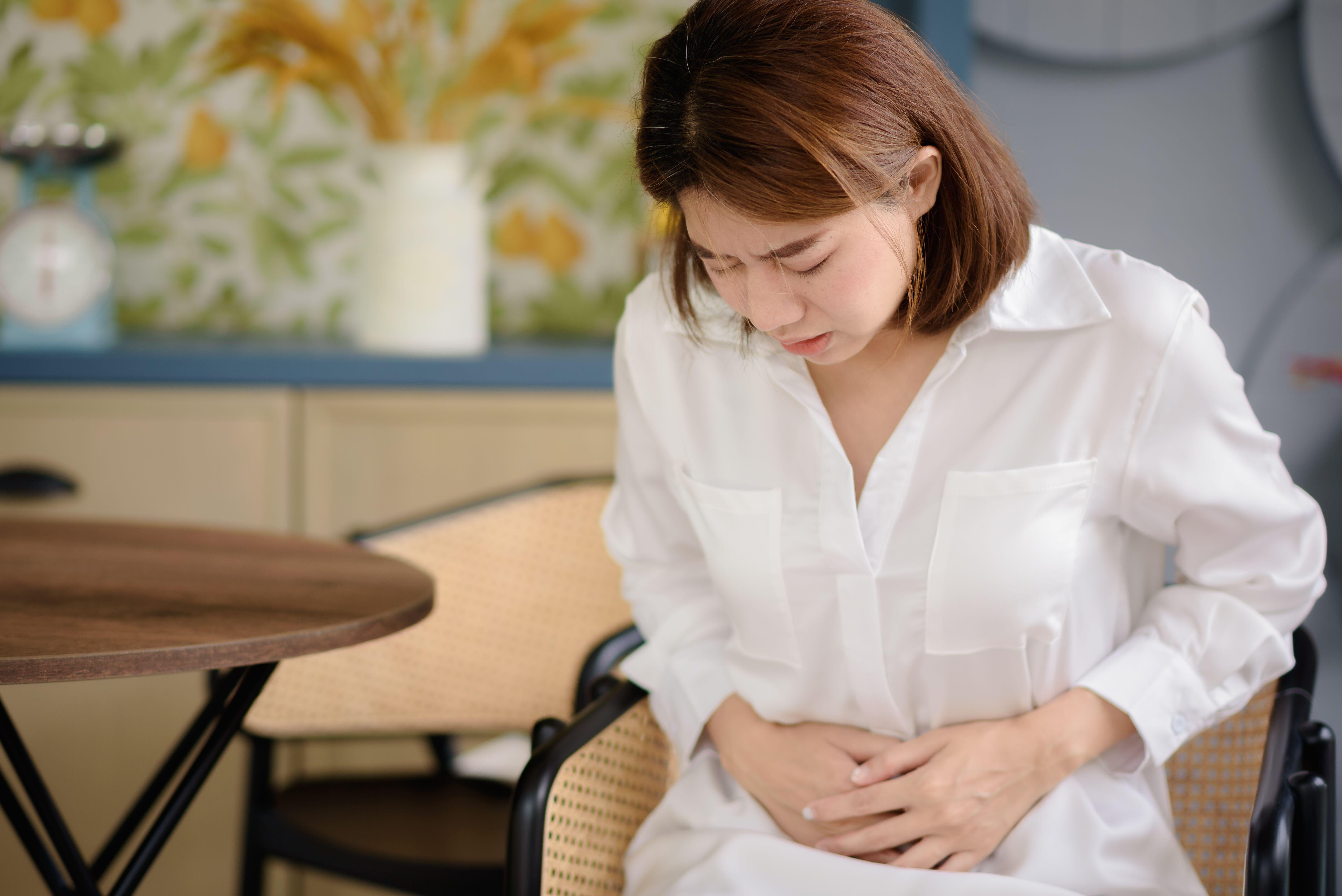 Tummy aches are a symptom of Crohn’s (Alamy/PA)