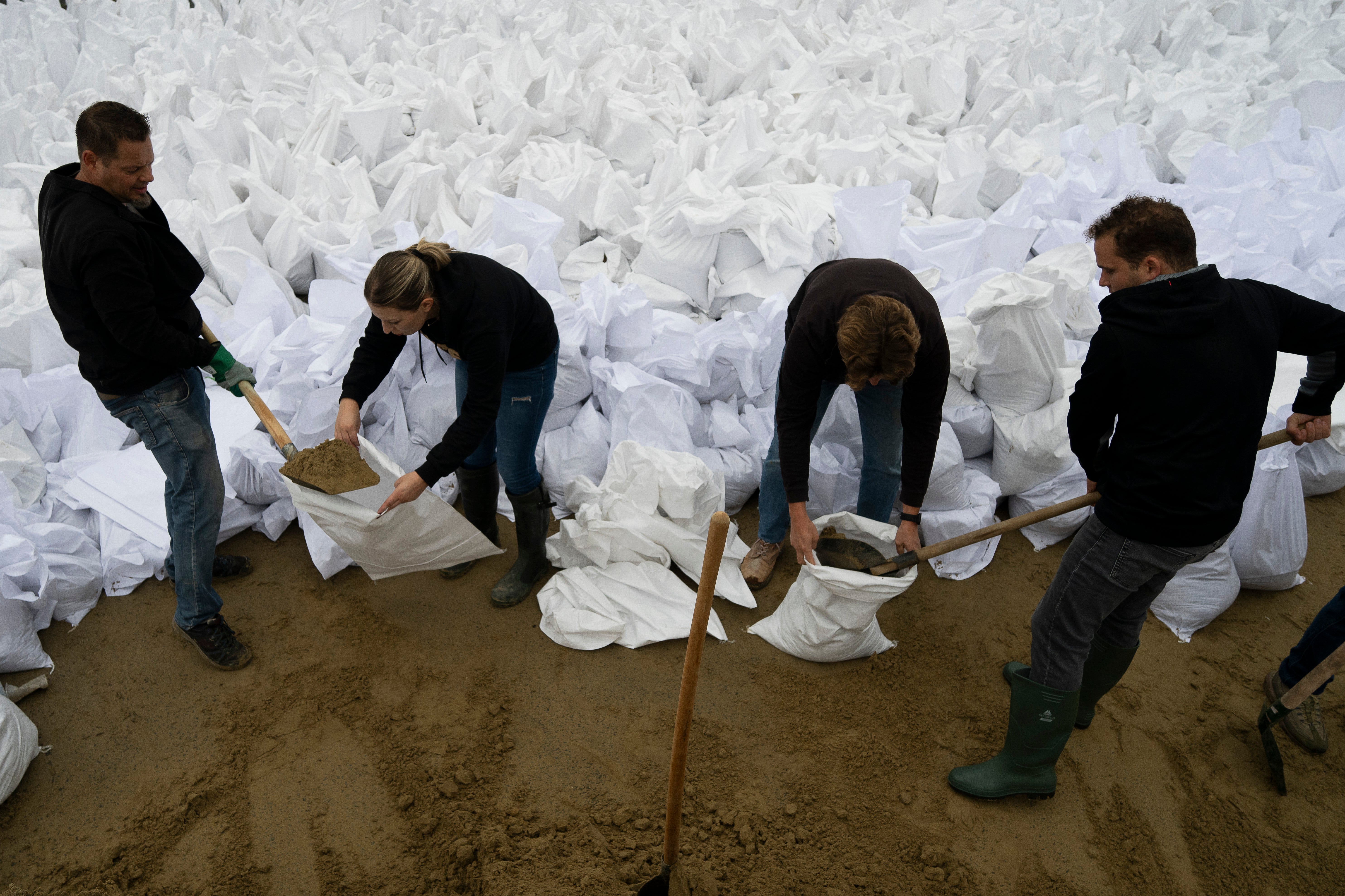 People fill sandbags to reinforce the dam due to the flooding of the Danube river