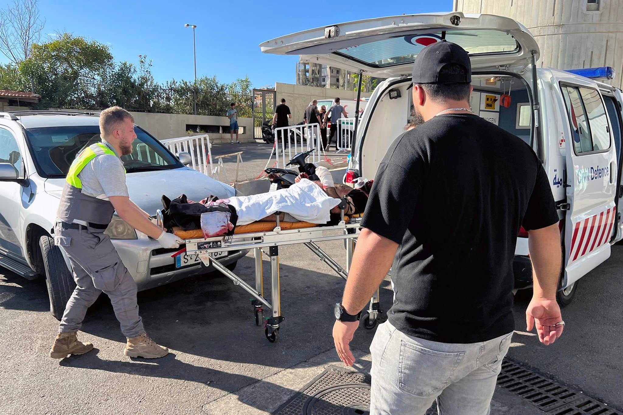 A wounded man is carried onto an ambulance after his pager exploded